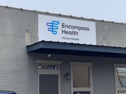 Exterior view of a building with an Encompass Health Home Health sign above the entrance.
