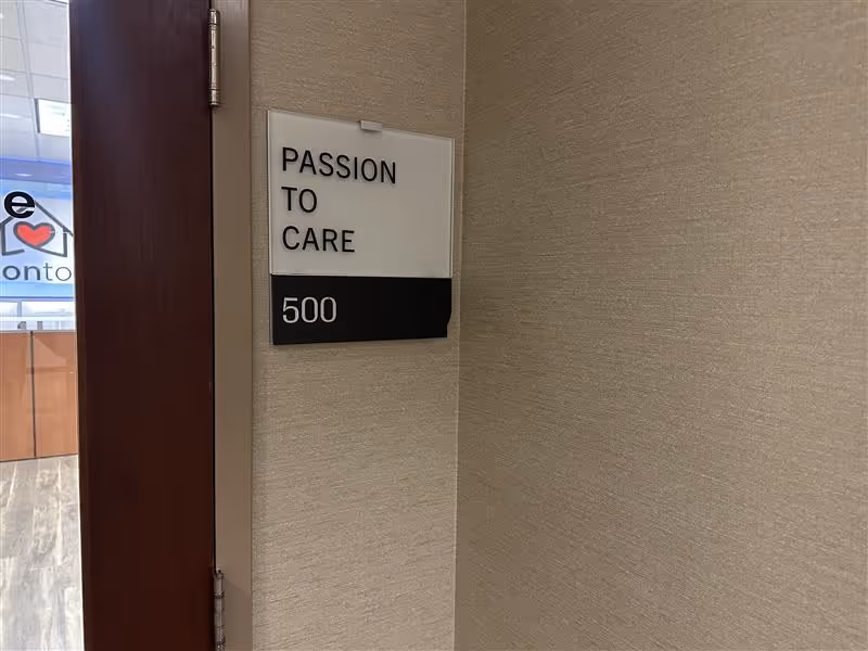 Interior hallway with a Passion to Care sign and room number 500.