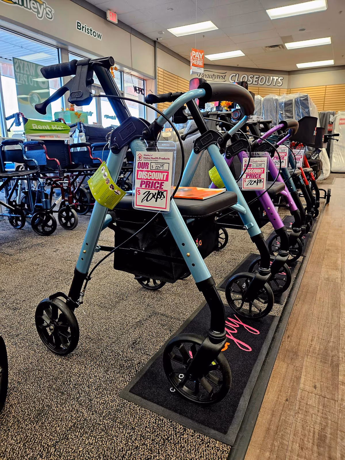 Inside Stanley's Home Health Mobility Center showroom, colorful mobility scooters line the display.