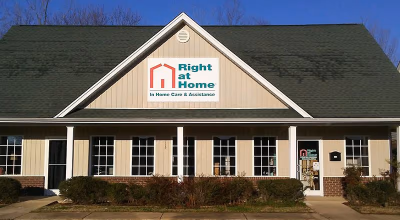 Front exterior of a Right at Home care facility with a sign above the entrance.