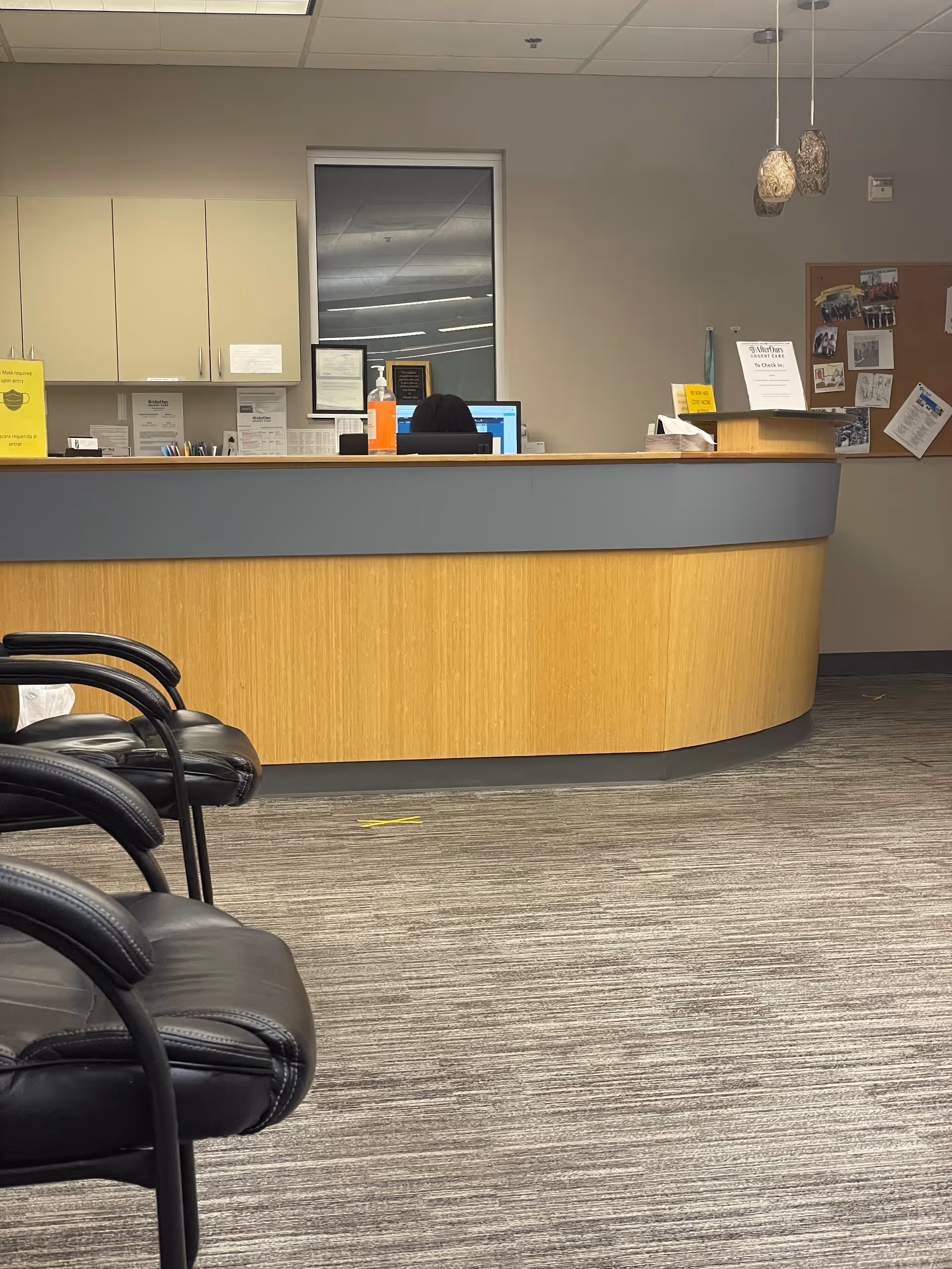 Reception area of an urgent care clinic with a curved counter.