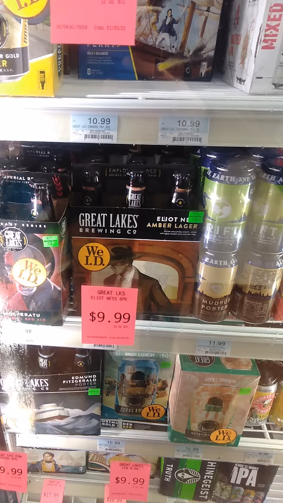 Interior view of beer cans and boxes on store shelves at Discount Drug Mart.