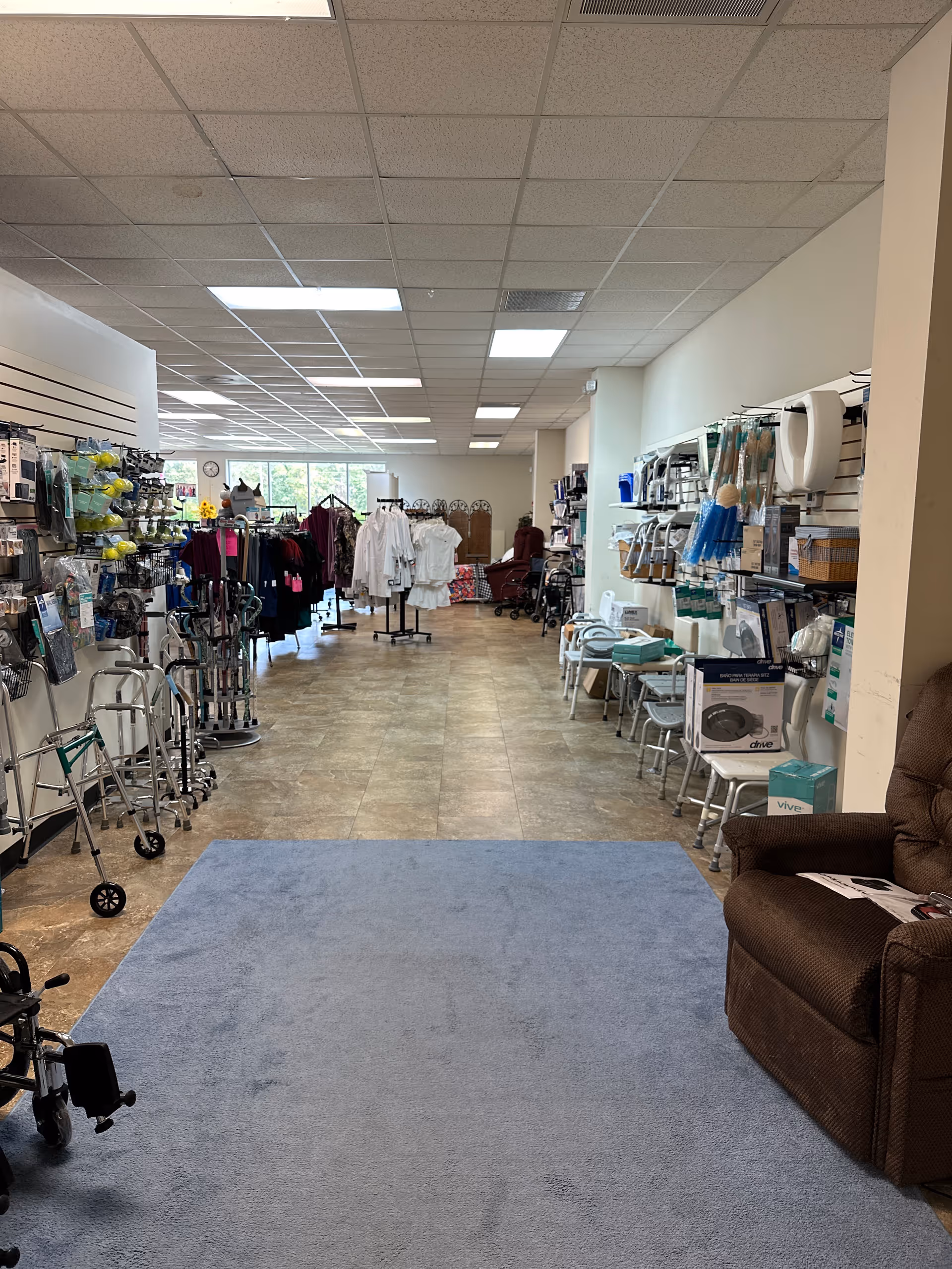 Bright indoor supply room in a senior care facility with mobility aids and chairs.