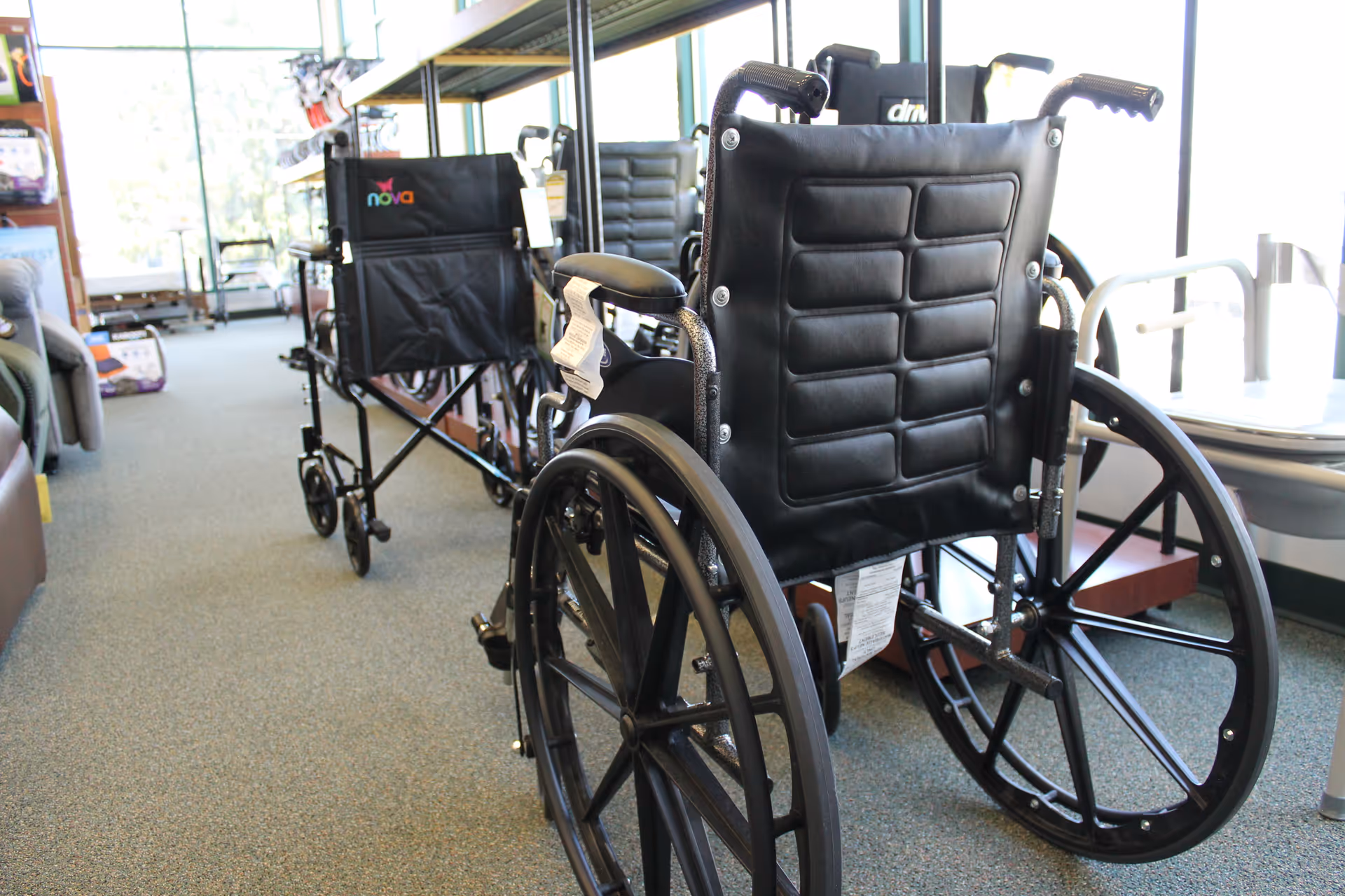 Wheelchairs lined up in a bright indoor area of a senior facility.