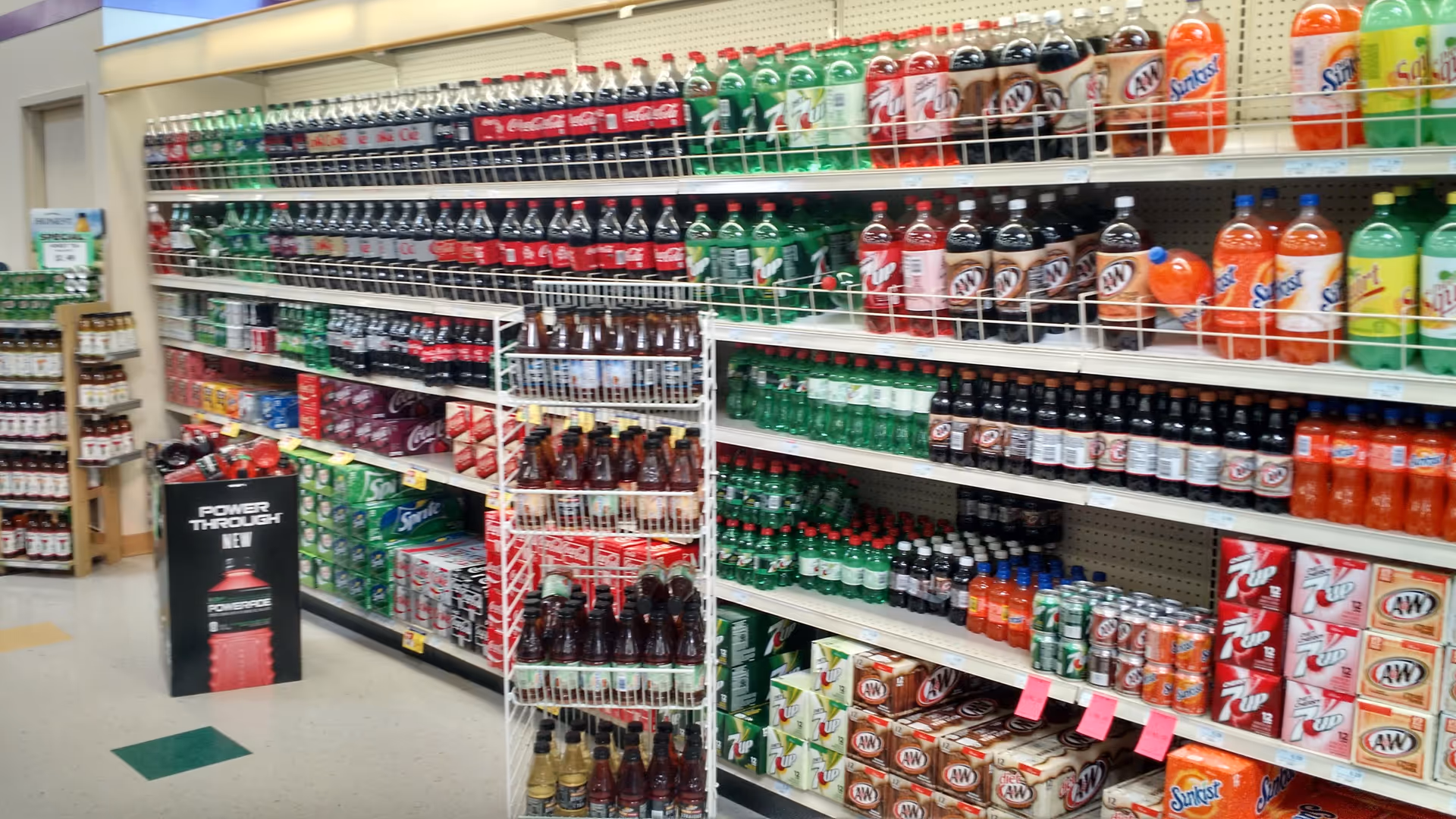Interior of Discount Drug Mart with beverage shelves lining the aisle.
