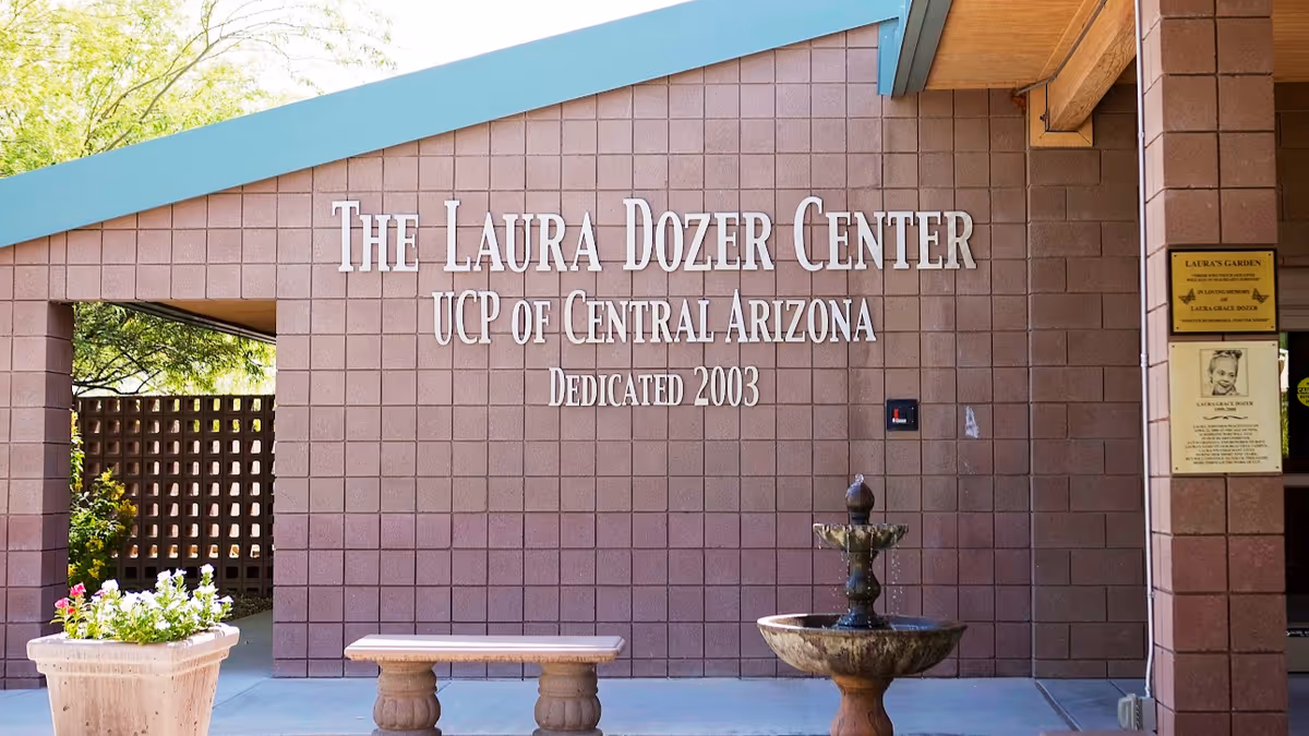 Exterior view of The Laura Dozer Center UCP of Central Arizona with fountain and bench.