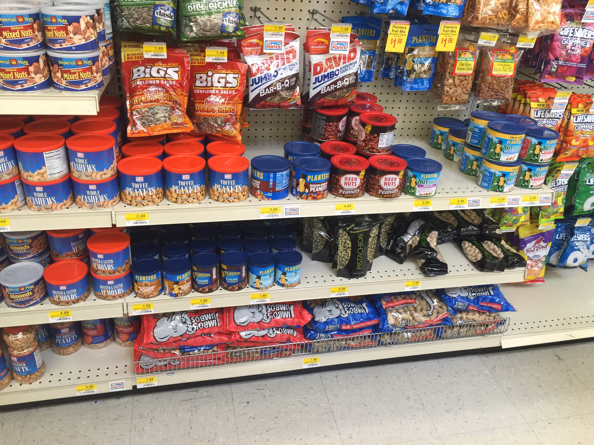 Store aisle at Discount Drug Mart with assorted nuts and snacks on shelves.