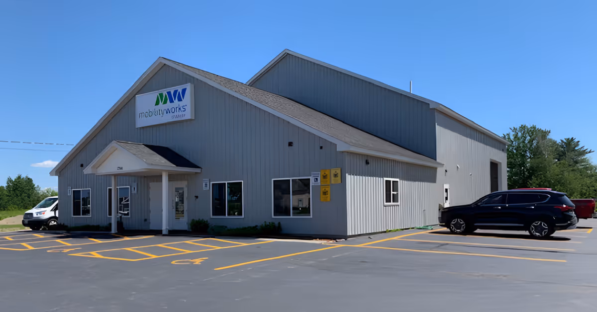 Gray metal building with MobilityWorks sign, windows, and a parking lot in front.