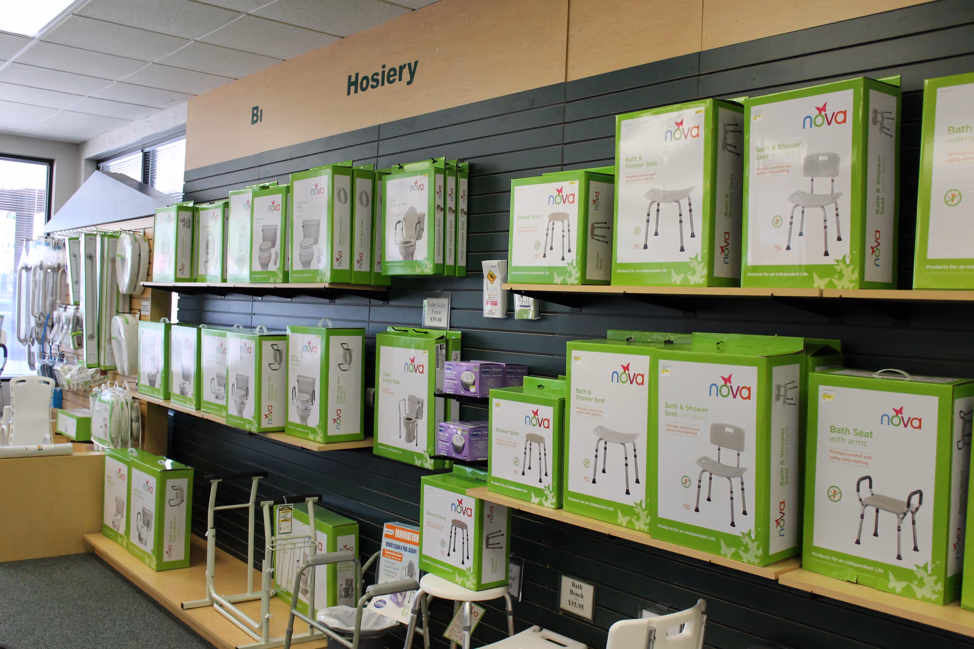 Retail display wall with boxed Nova bath seats and senior care aids.