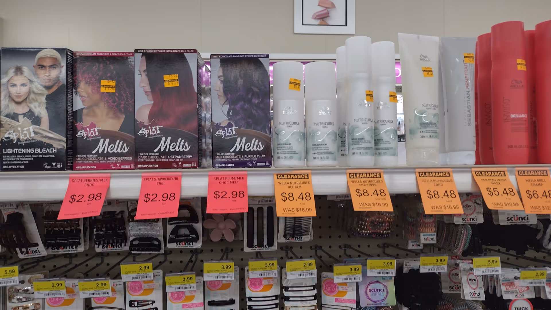 Discount Drug Mart aisle with hair products and price-tagged boxes.