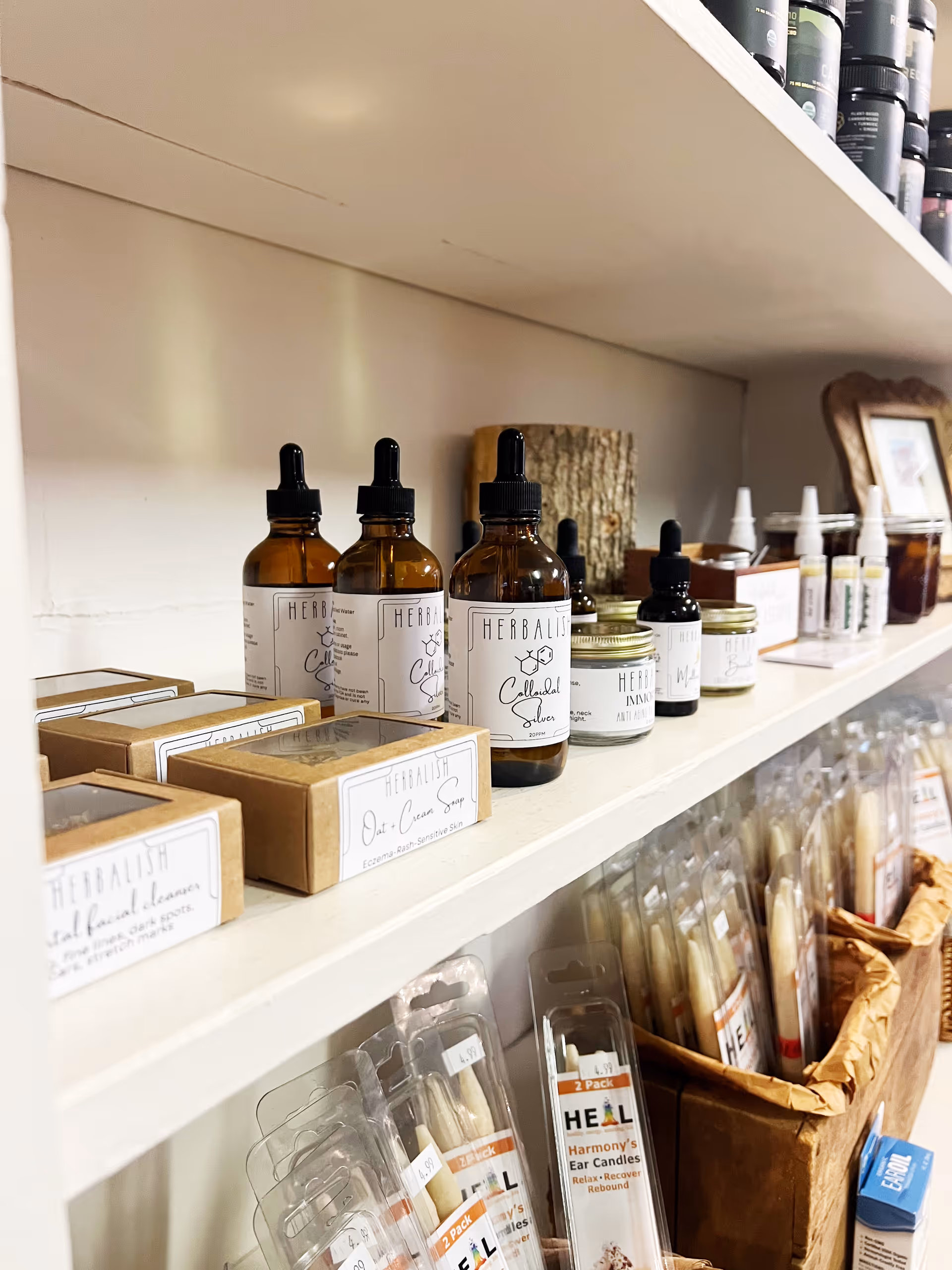 Shelves display Herbal Solutions bottles, jars, and packaging in a neat retail-style product area