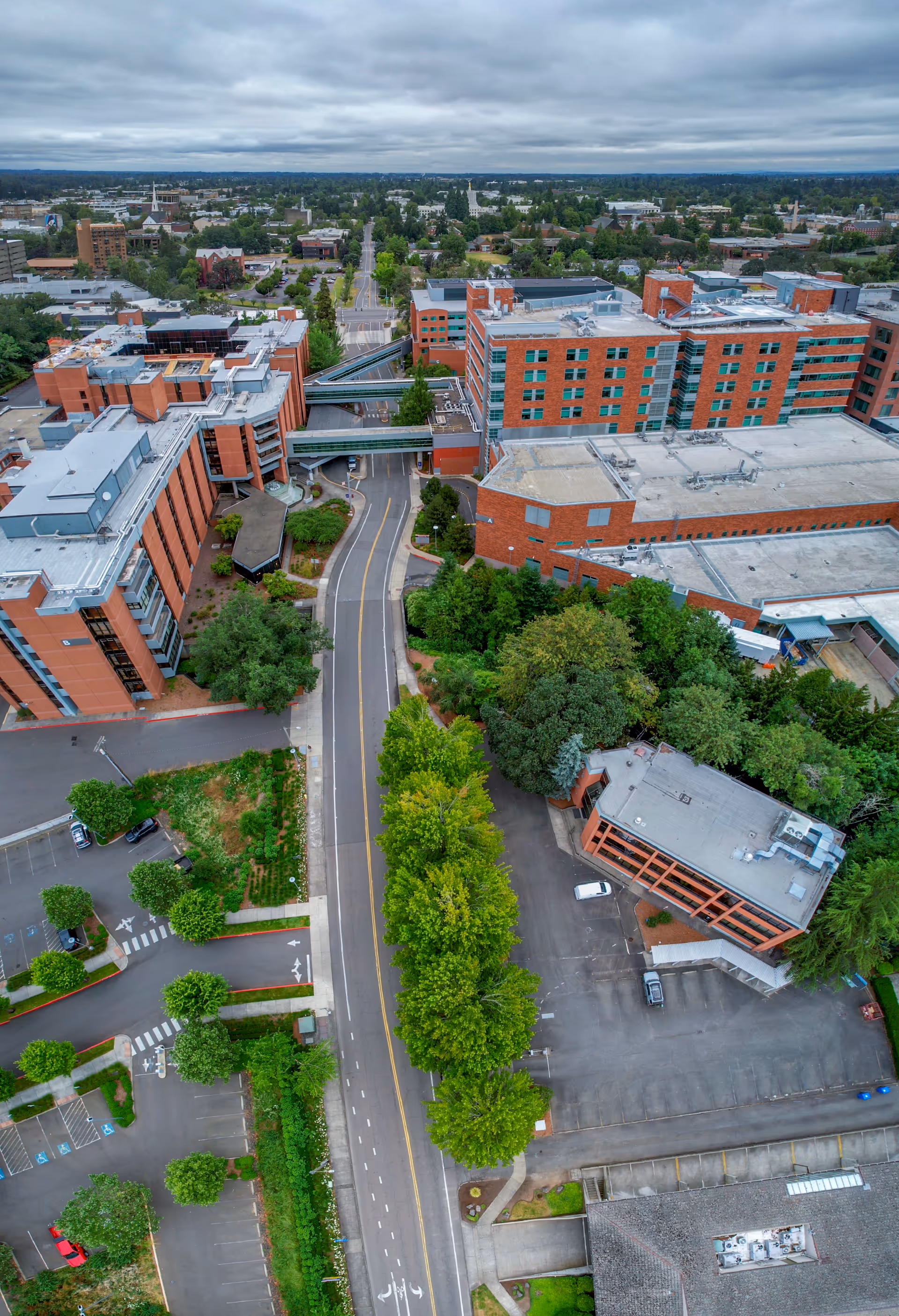 Aerial view of Salem Health Emergency Department campus with red-brick buildings and surrounding trees.