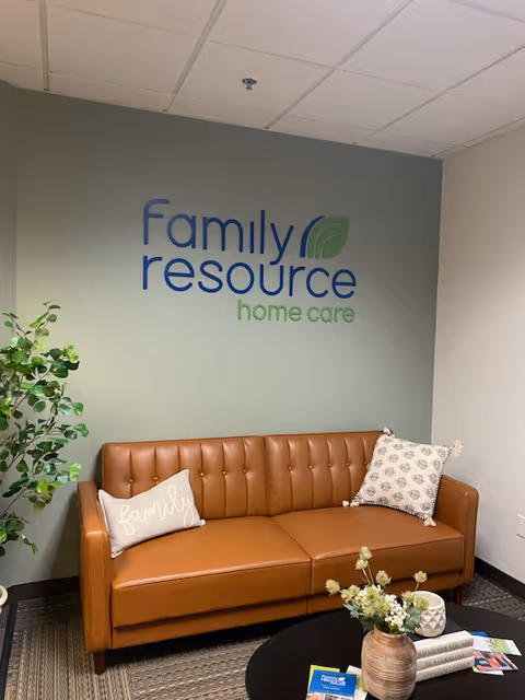 Brown leather sofa against a wall with Family Resource Home Care logo.