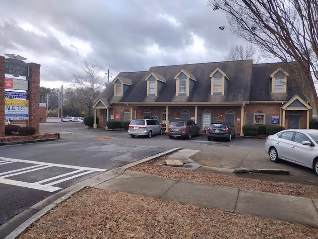 Front view of Mabry Medical Services LLC building with brick facade and parked cars.