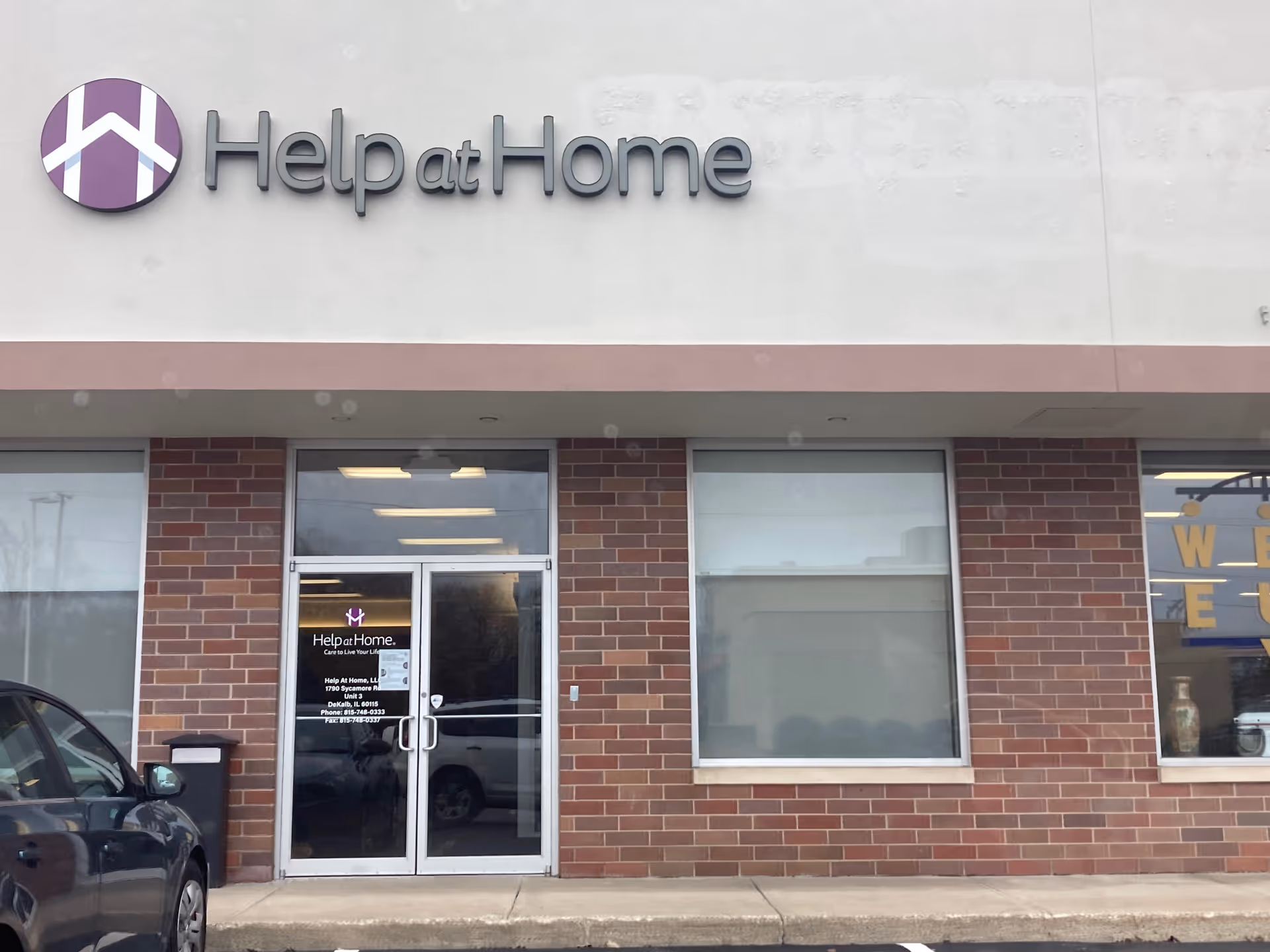Help at Home storefront with brick exterior and glass entrance doors.