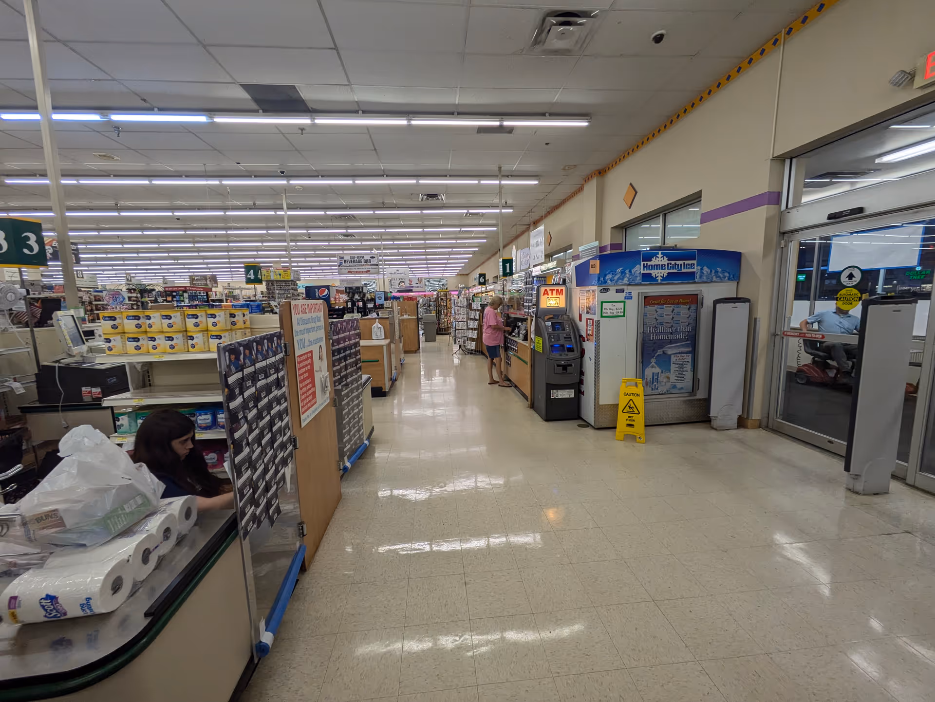 Wide interior view of a Discount Drug Mart store with checkout counters and aisles.