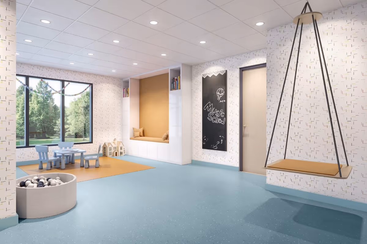 Bright indoor playroom with a swing, window seat, toy table, and ball pit.