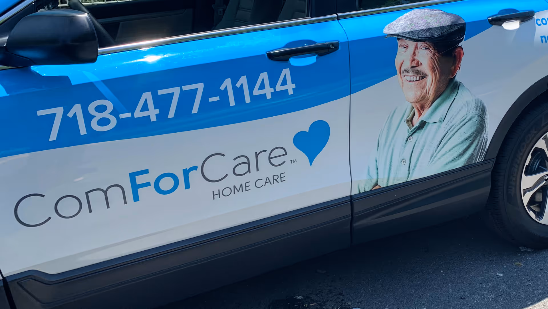Blue ComForCare Home Care promotional van with phone number and elderly man image.