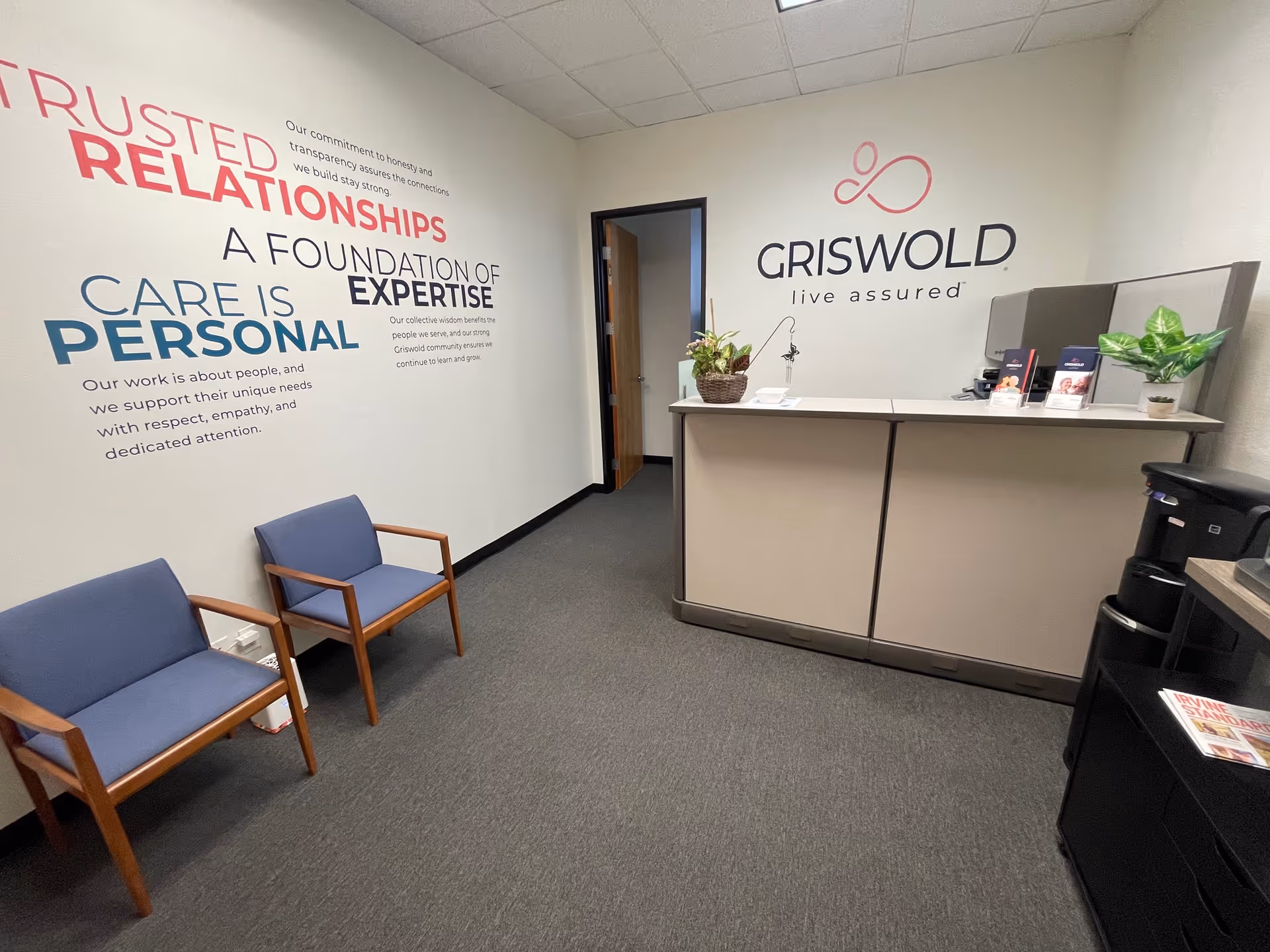 Reception area inside Griswold Home Care with front desk and seating.