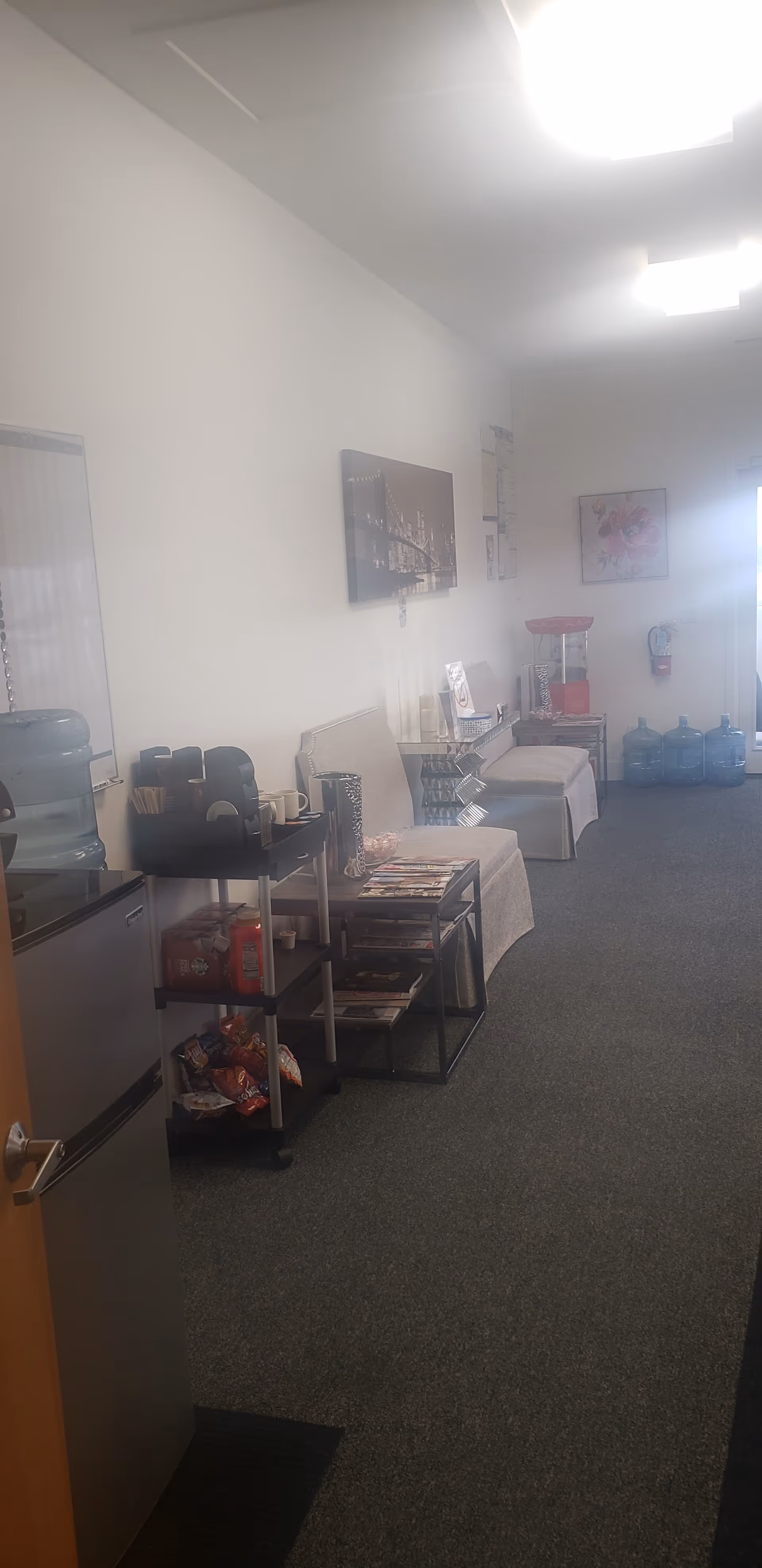 Indoor lounge and snack area in a senior facility with beverage station.