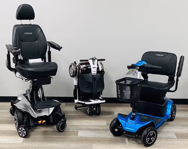 Three mobility devices, including two scooters and a chair, in a clean indoor facility.