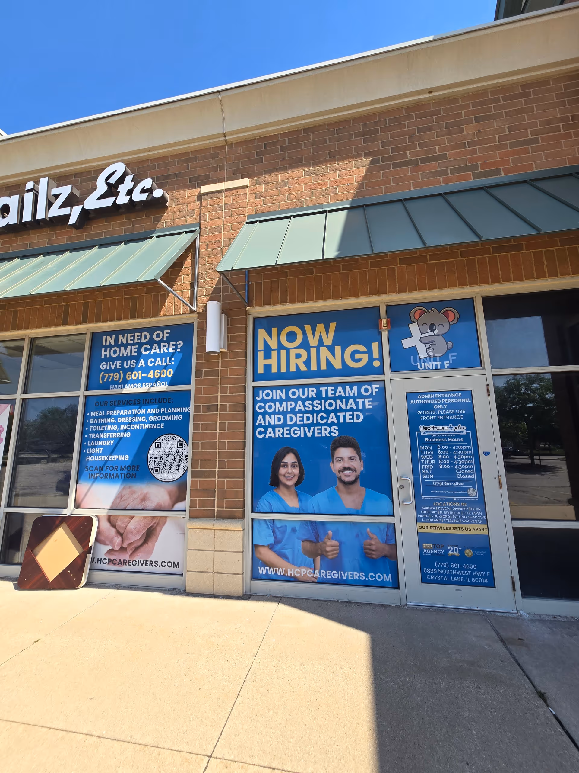 Exterior storefront for Healthcare Plus Caregivers with now hiring posters in windows.