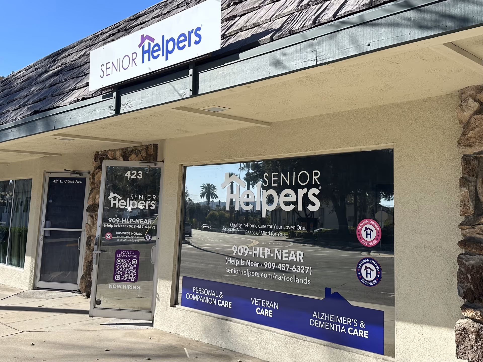 Exterior view of a Senior Helpers storefront with large logo windows and signage.