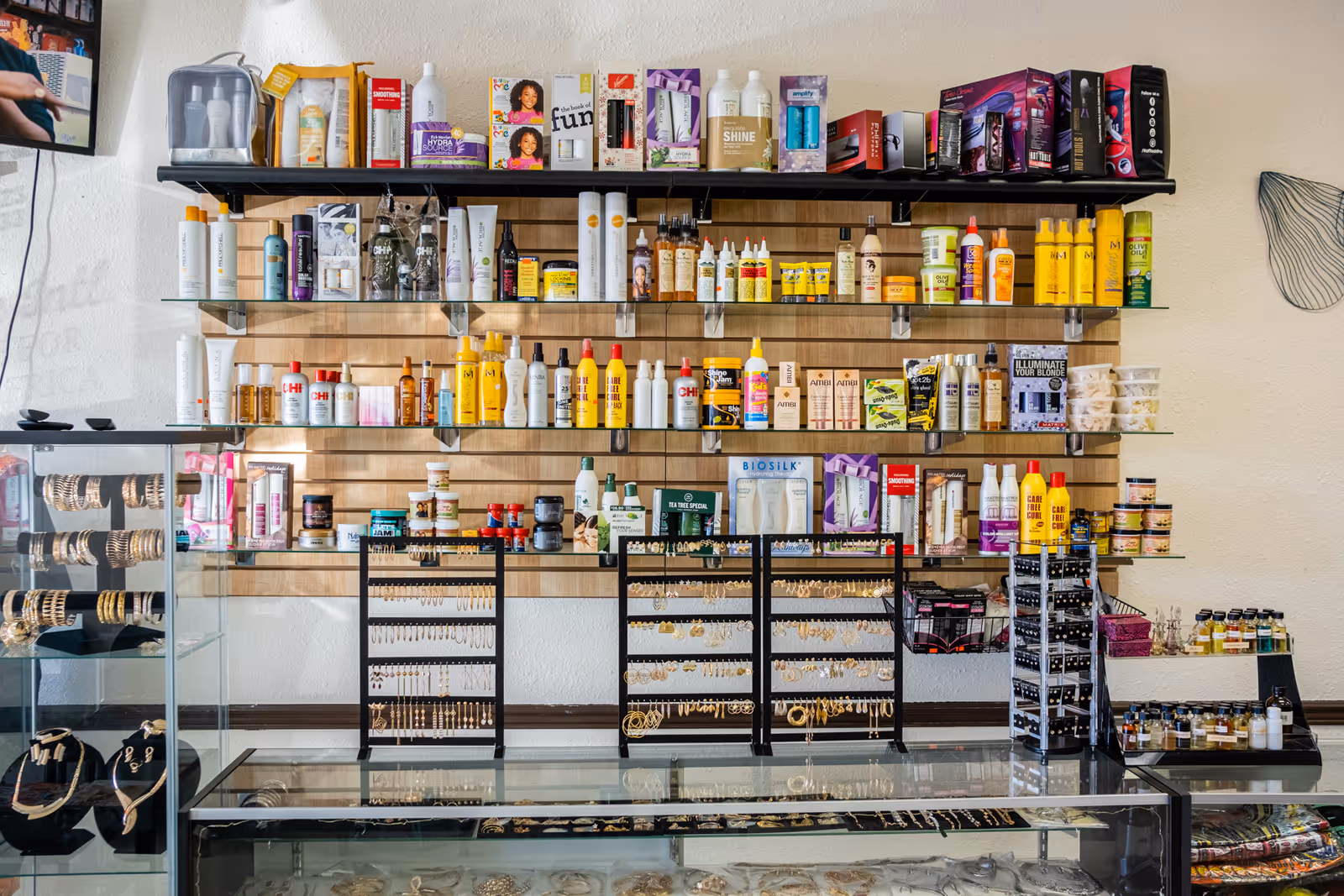Interior of a beauty shop with shelves of haircare products and jewelry displays