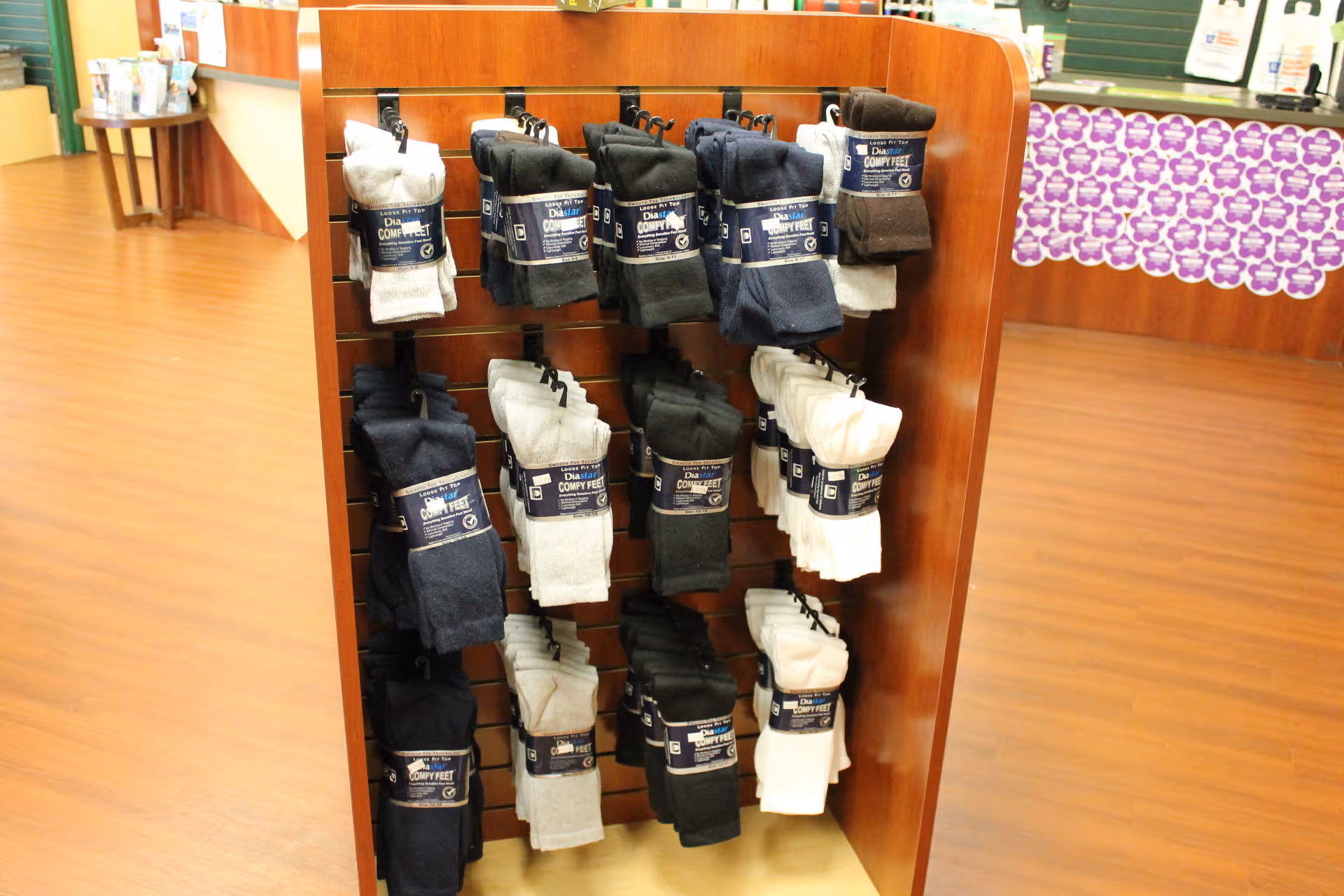 Wooden display rack with packaged socks inside a senior facility.