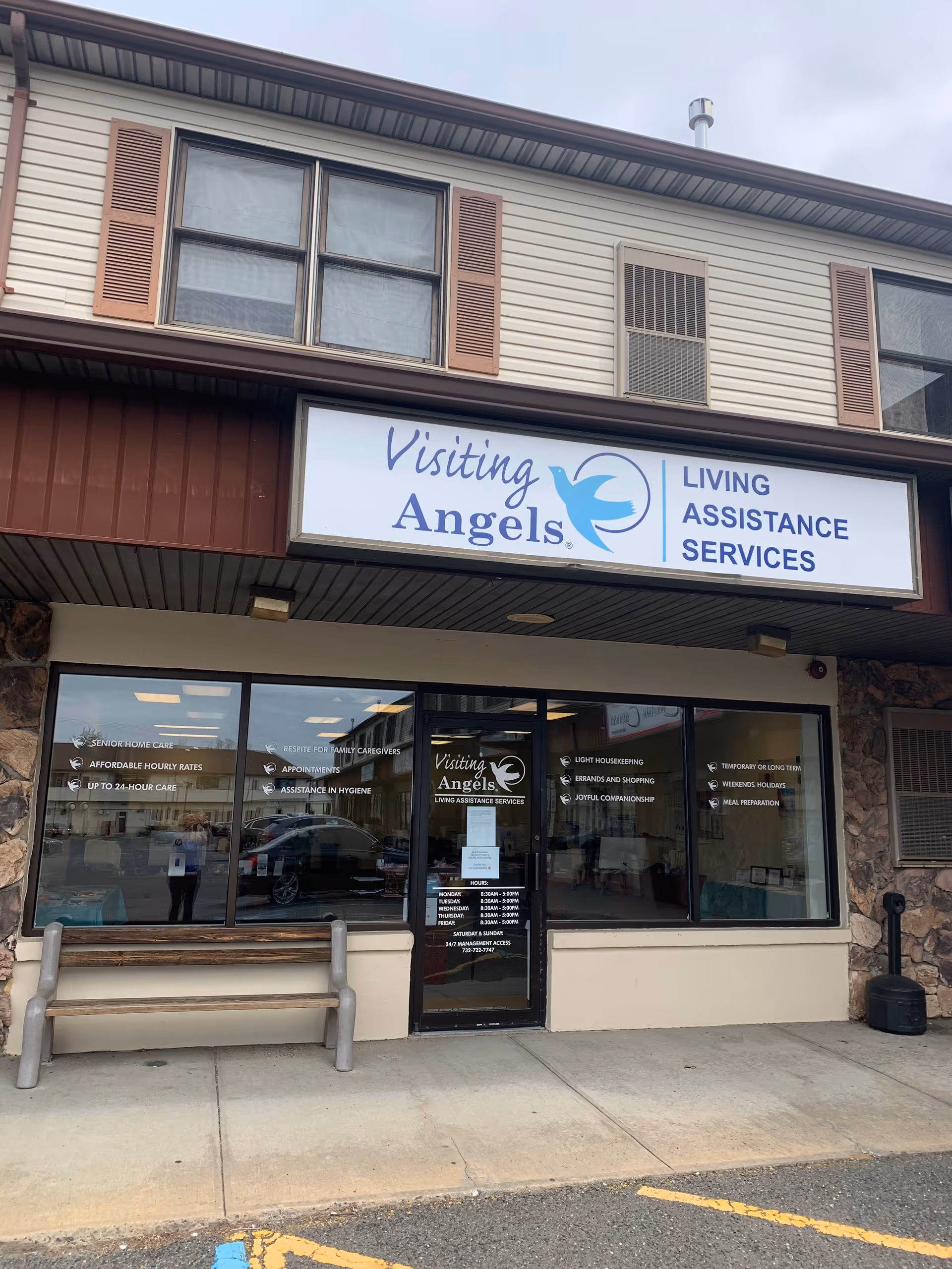 Exterior storefront of Visiting Angels Senior Home Care with sign and large windows.