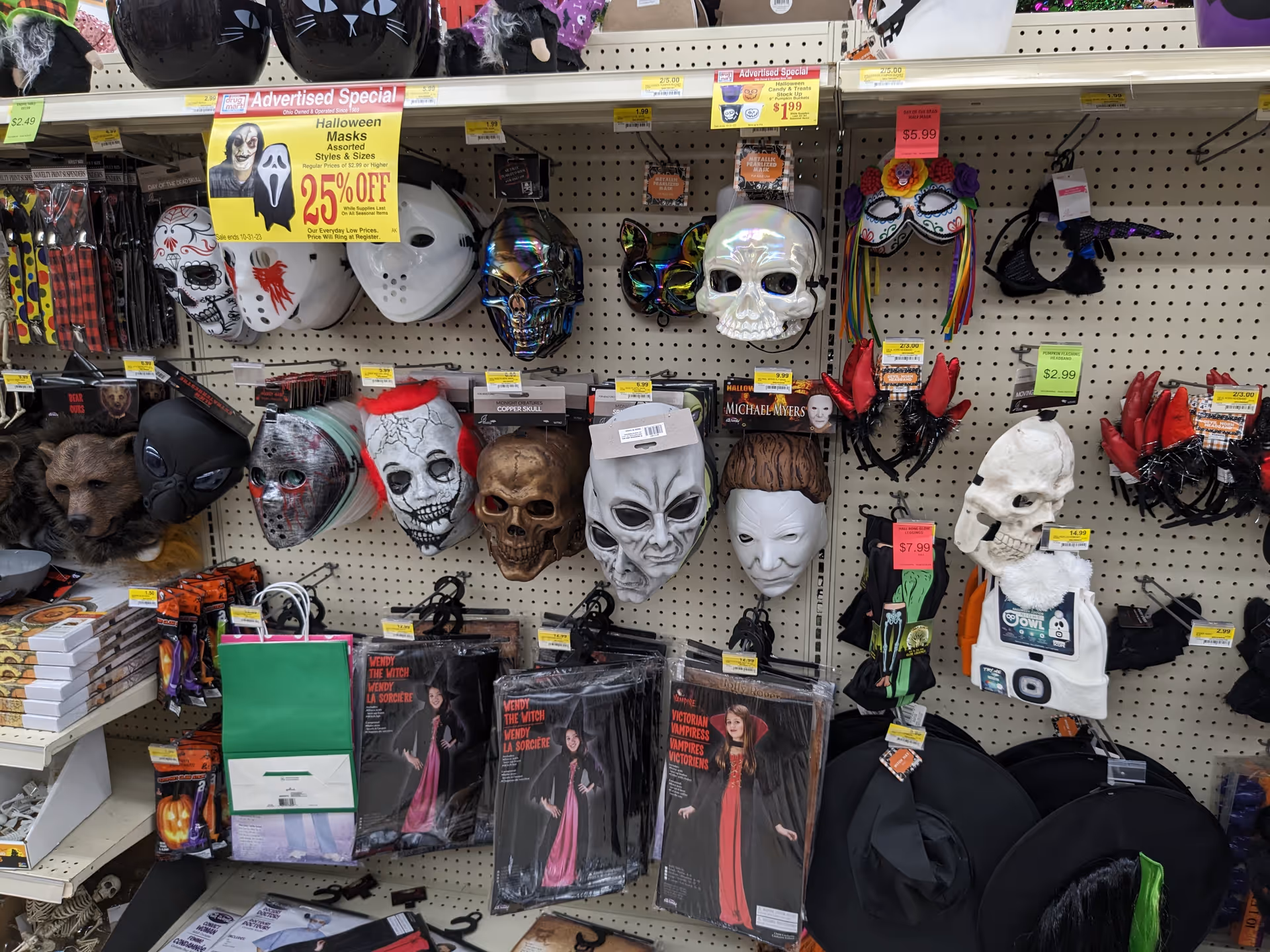 Shelves lined with Halloween masks and costumes in a Discount Drug Mart store.