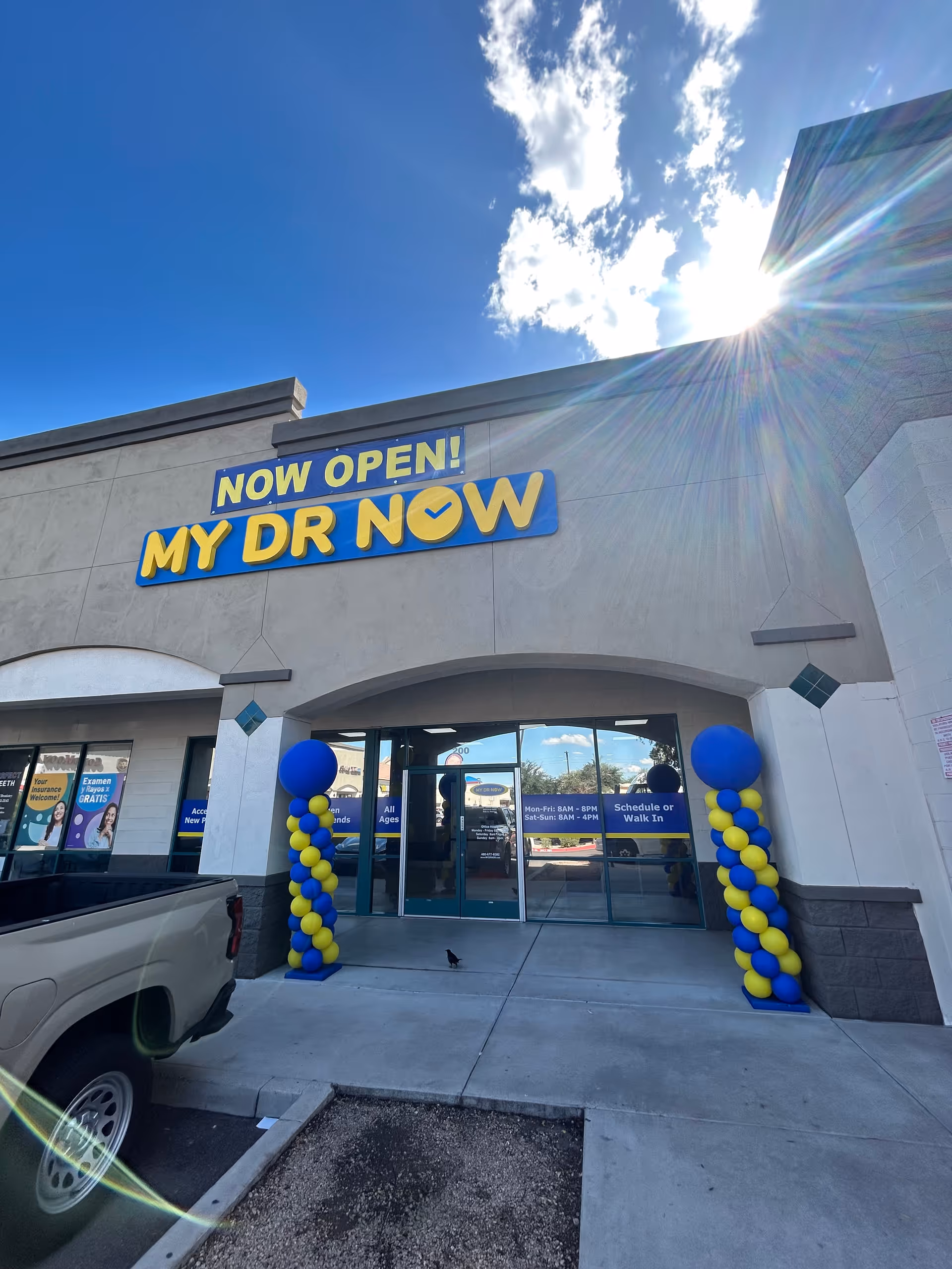 Front view of a building entrance featuring the MY DR NOW sign and blue-yellow balloons.