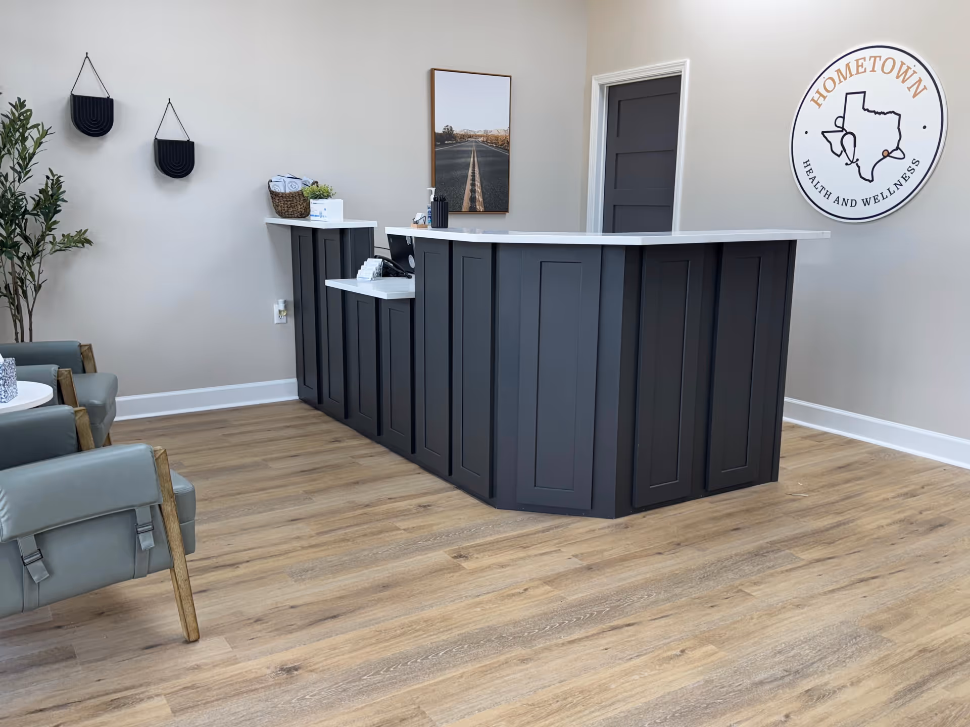Modern reception desk inside a Hometown Health and Wellness facility with seating and decor.