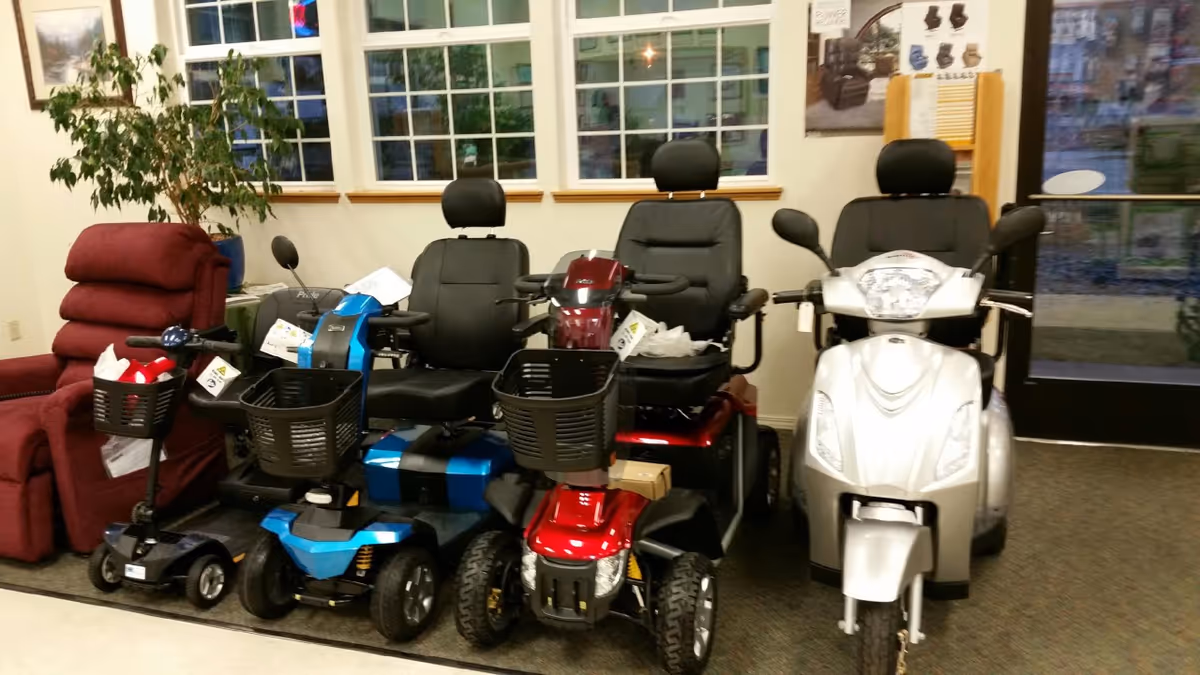 Indoor facility lobby showcasing multiple mobility scooters beside a red recliner chair.