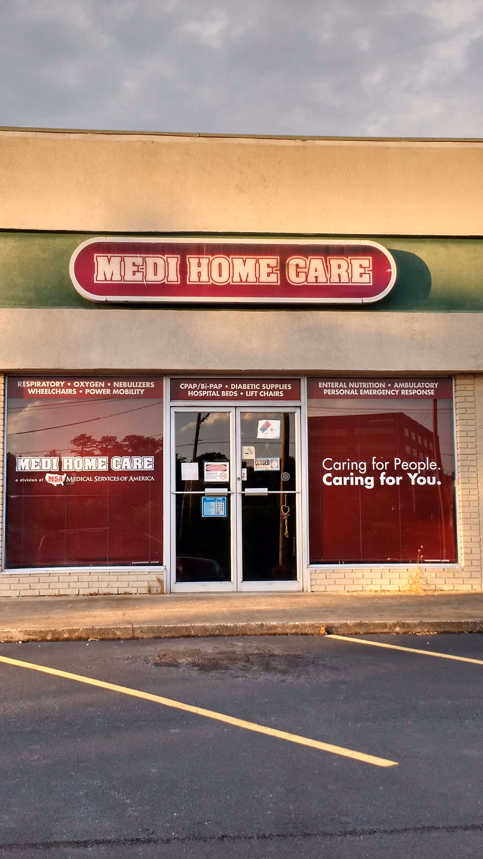 Front view of Medi Home Care storefront with red signage and glass entrance doors.