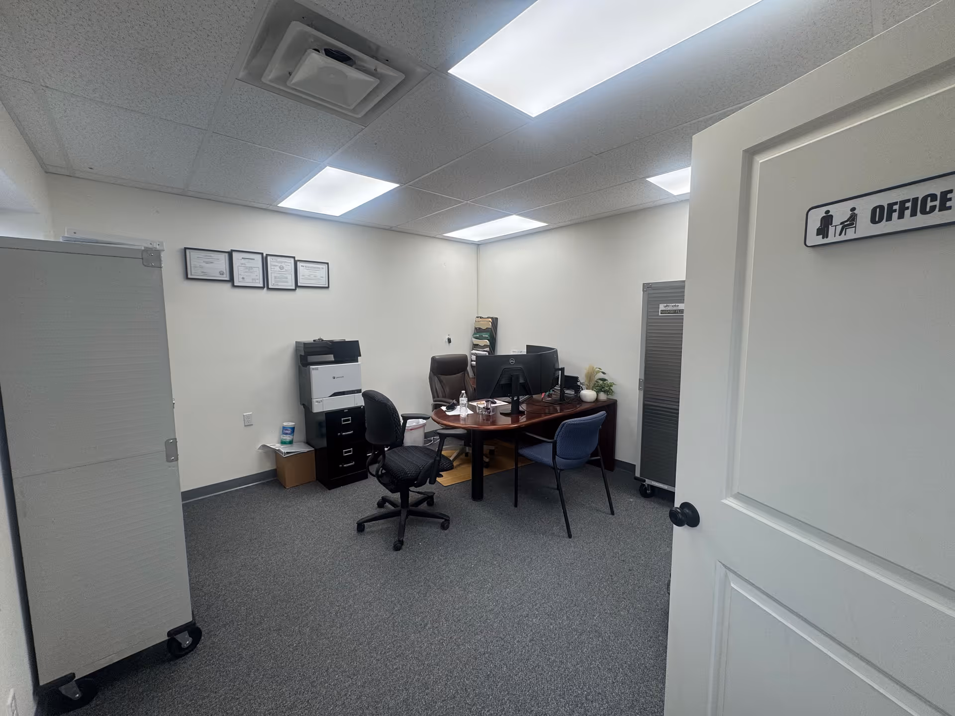 Small office in a senior facility with desk, computer, and filing cabinets.