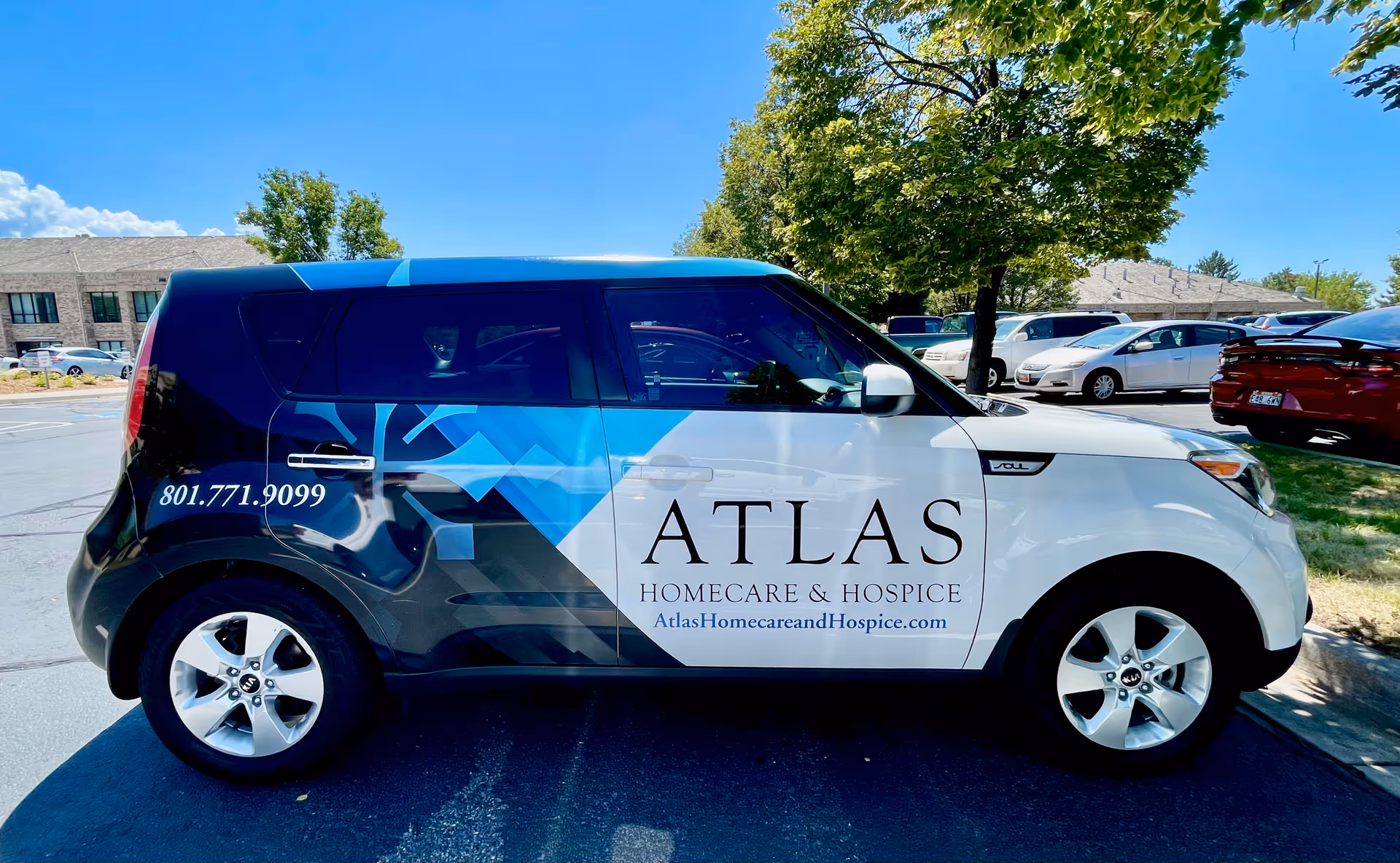 Branded Atlas Homecare and Hospice van with blue graphics parked in a sunny lot.