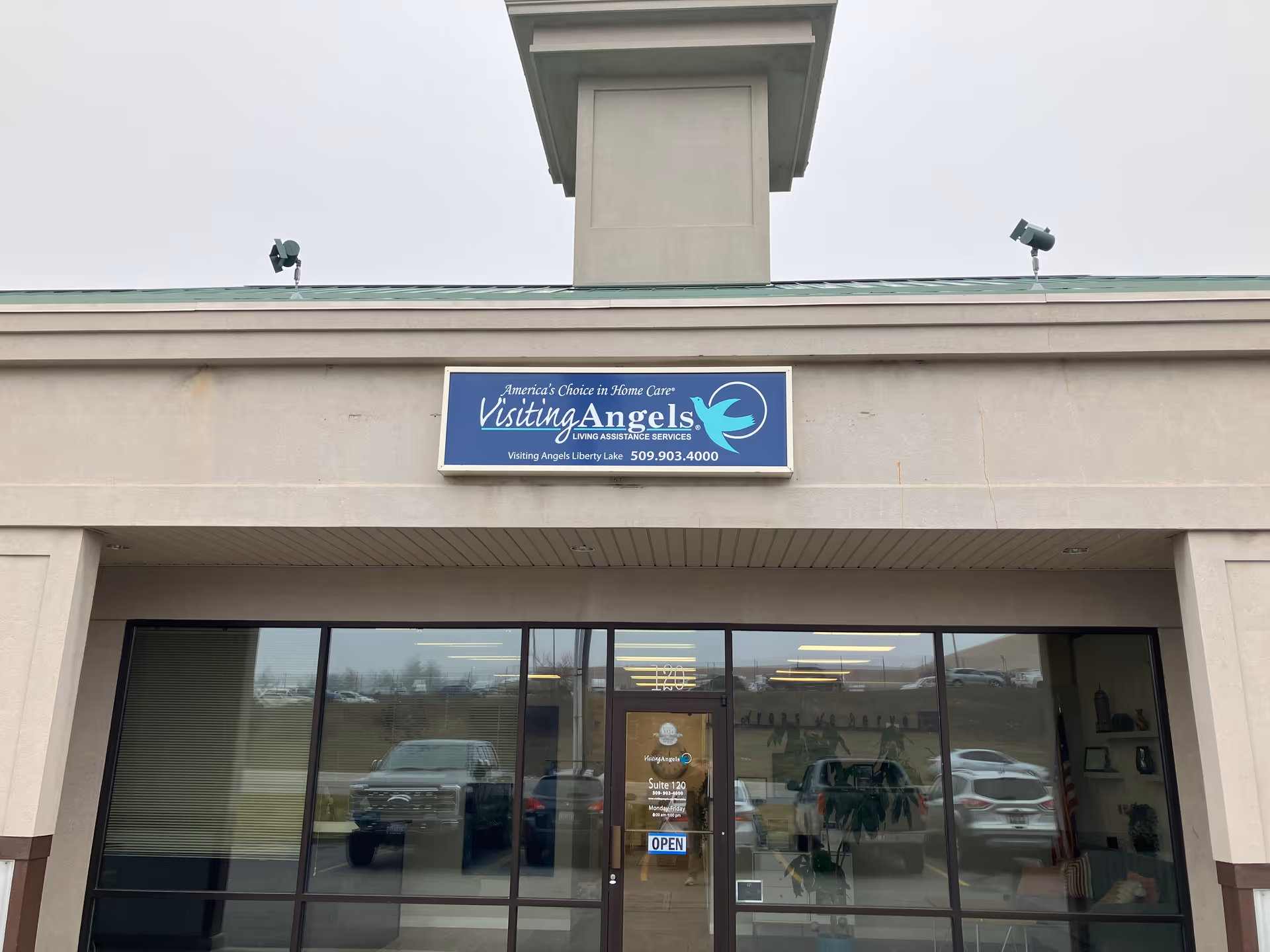 Front exterior of Visiting Angels senior home care building with glass doors.