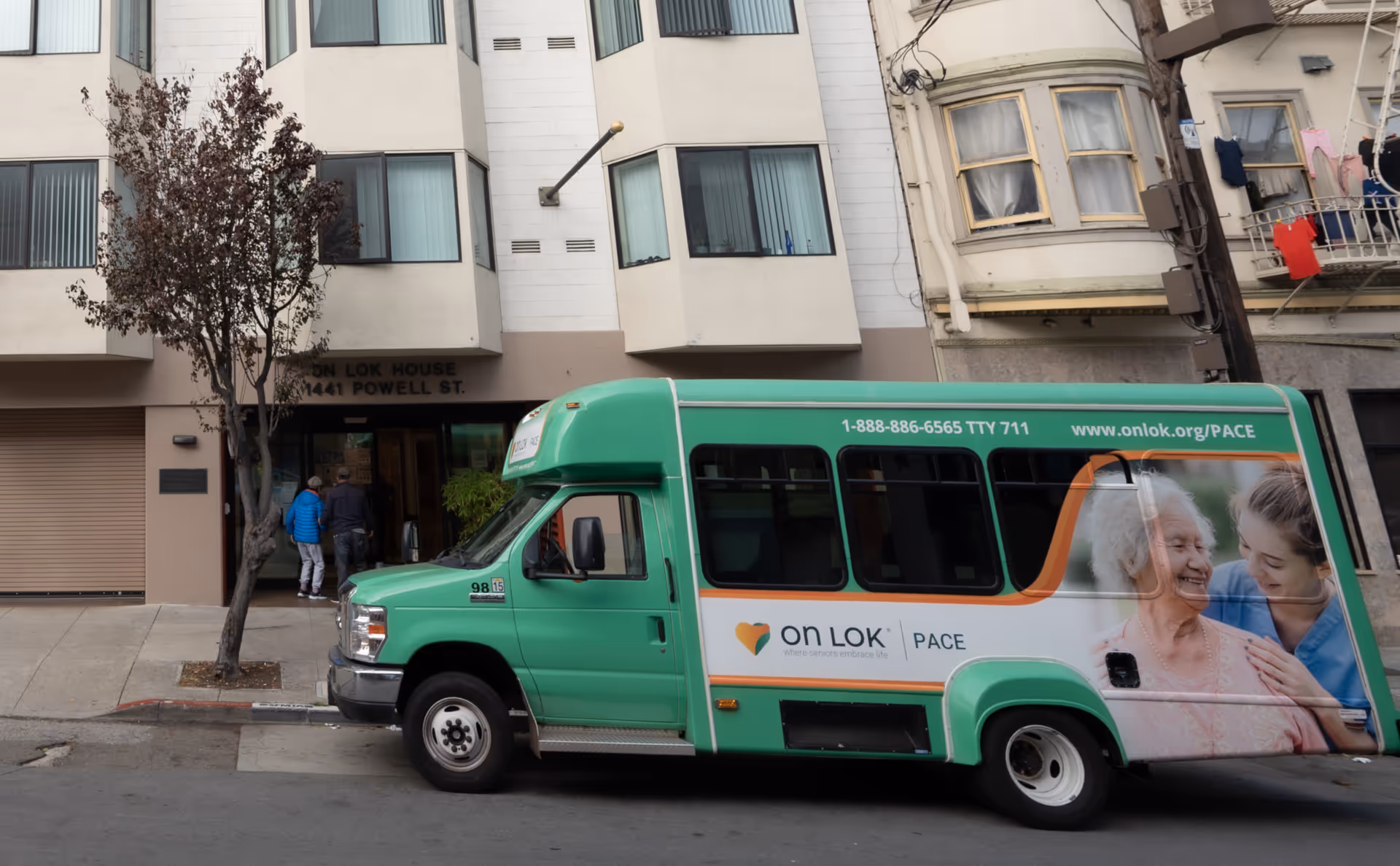 Green On Lok PACE shuttle bus parked in front of a building on Powell Street.
