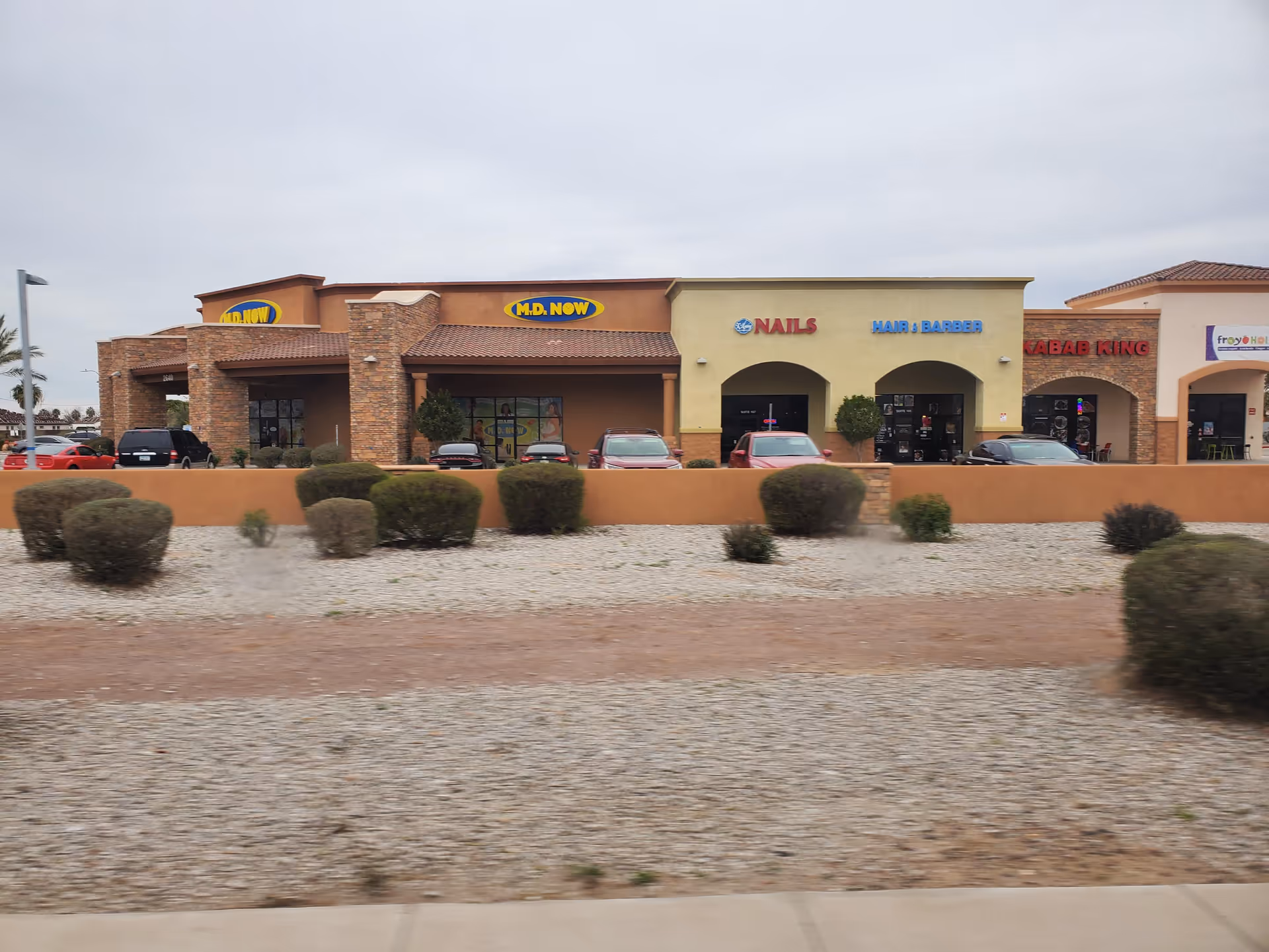 Exterior view of a strip mall with My Dr Now and other storefronts