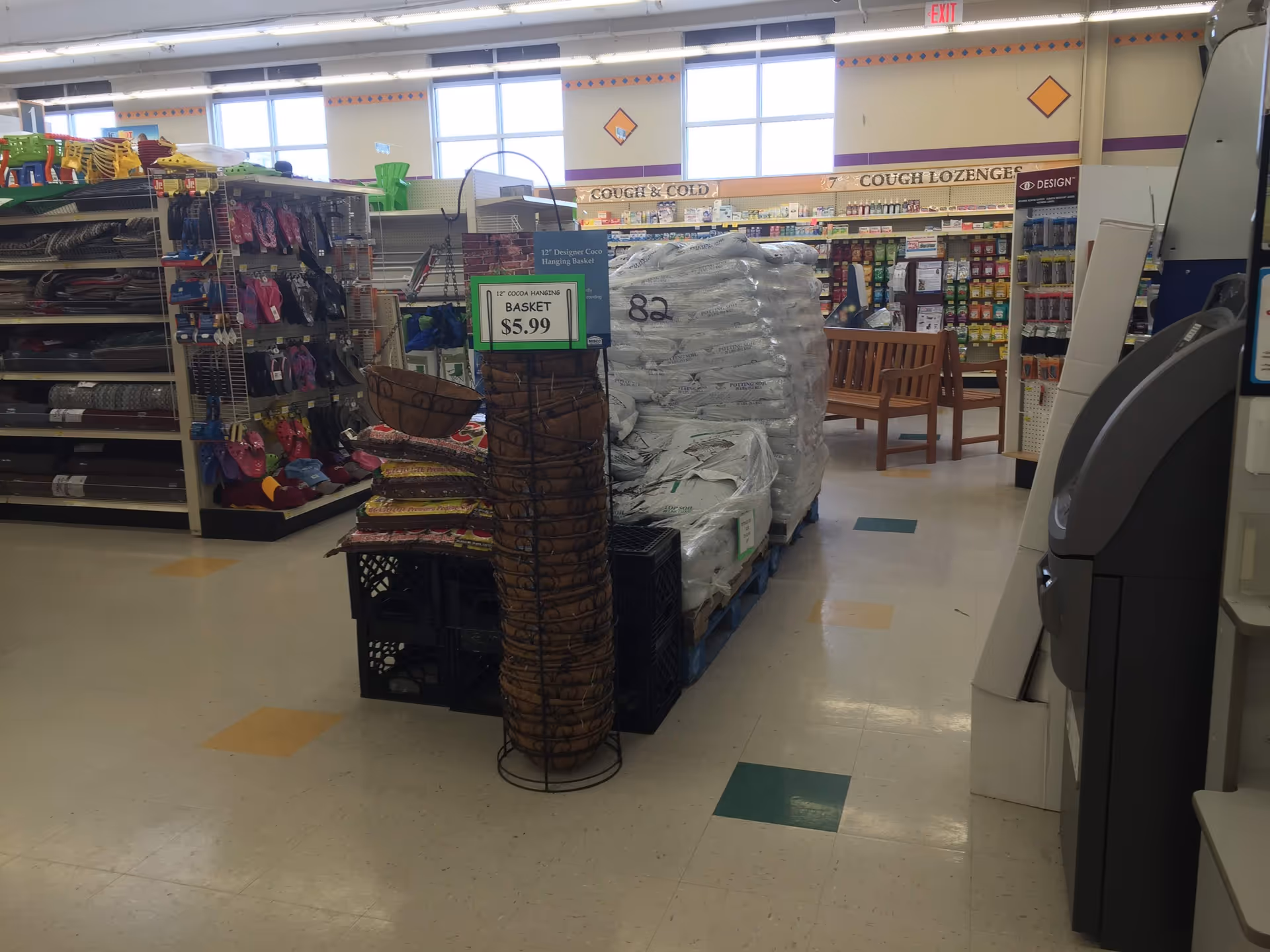 Inside a Discount Drug Mart store, shelves stocked with merchandise and a checkout area.
