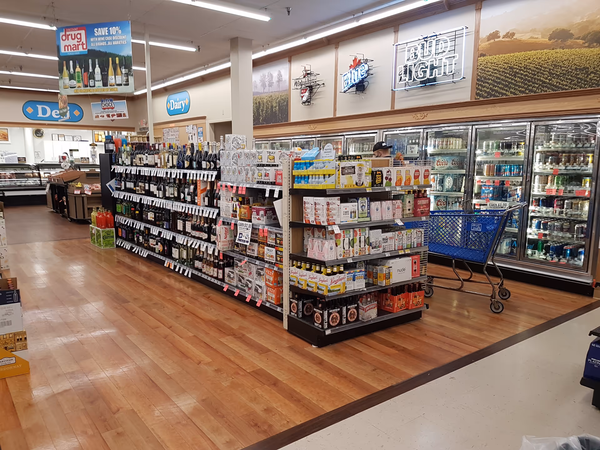 Inside Discount Drug Mart: shelves of products and a refrigerated section on the right.