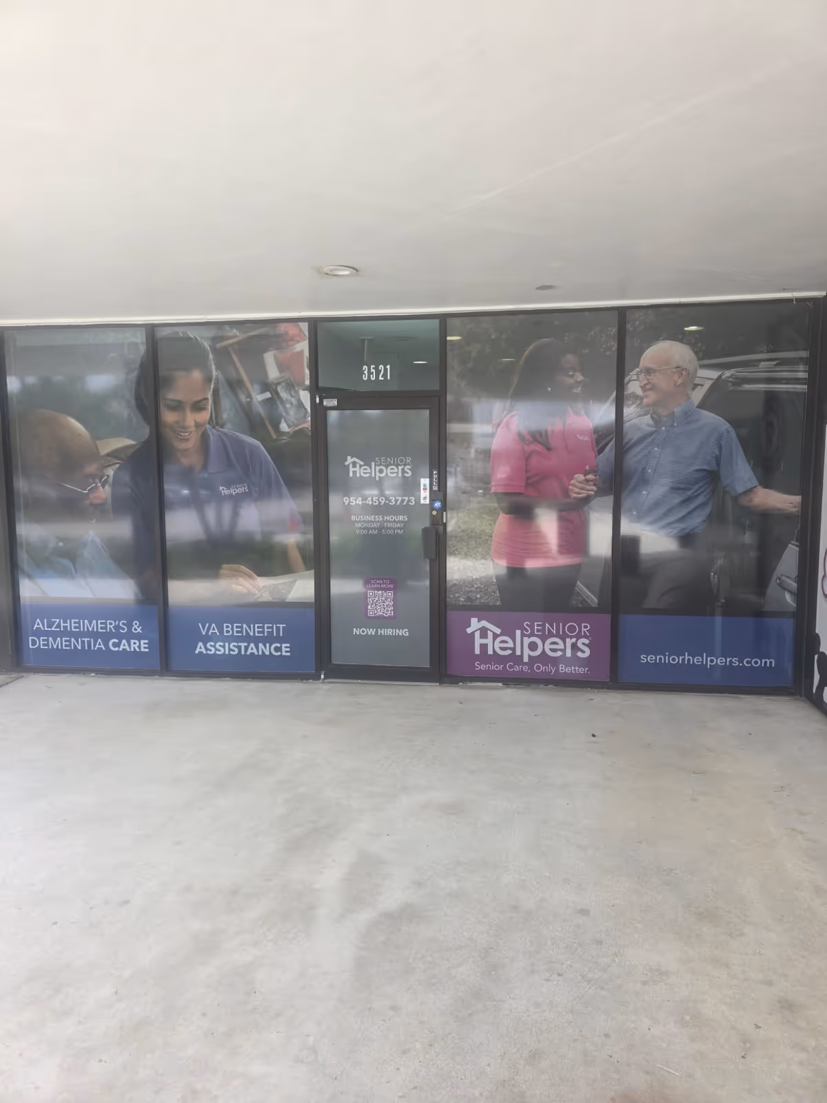Senior Helpers storefront with large window ads featuring caregivers and seniors.