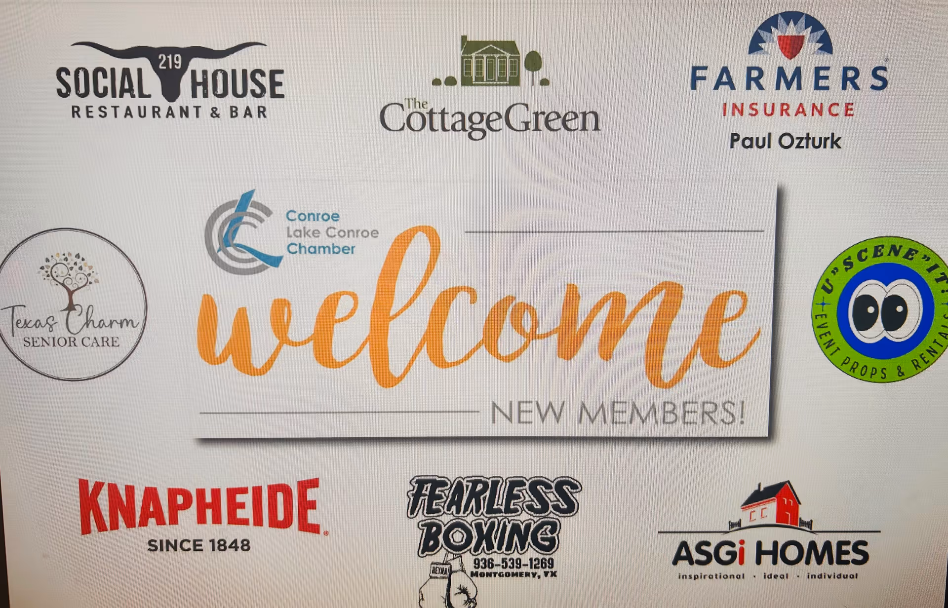 A wall-mounted welcome board with various facility logos and sponsor emblems.