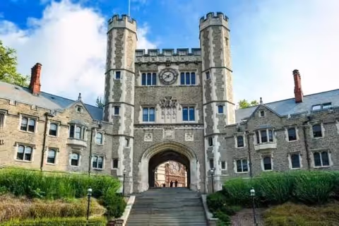Castle-like stone building with an arched central gateway and tall towers.