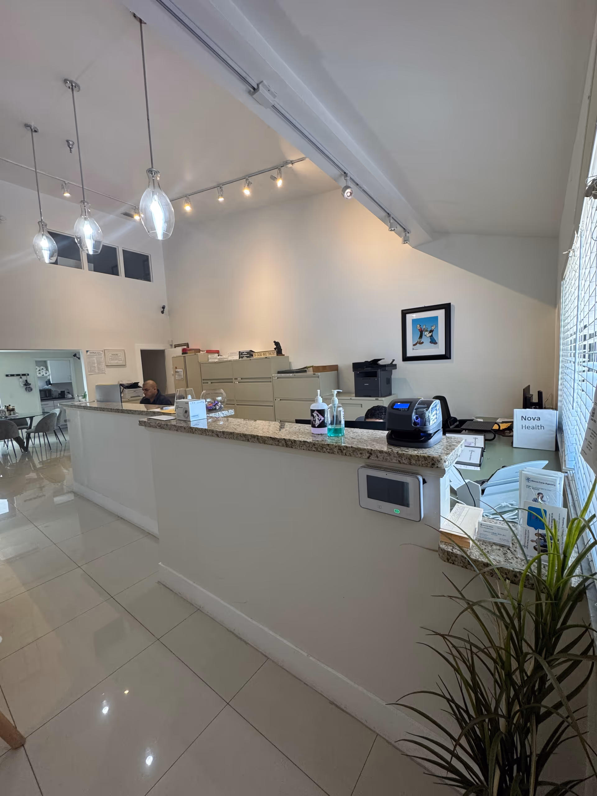 Reception counter inside Nova Care Agency and Nova Rehabilitation, with staff at the desk.