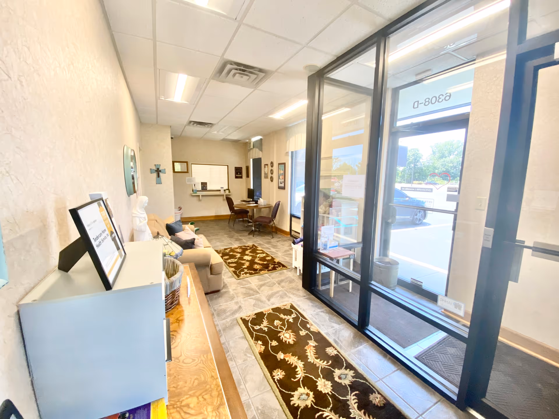 Interior lobby of Tendercare Home Health Services with seating and glass doors.