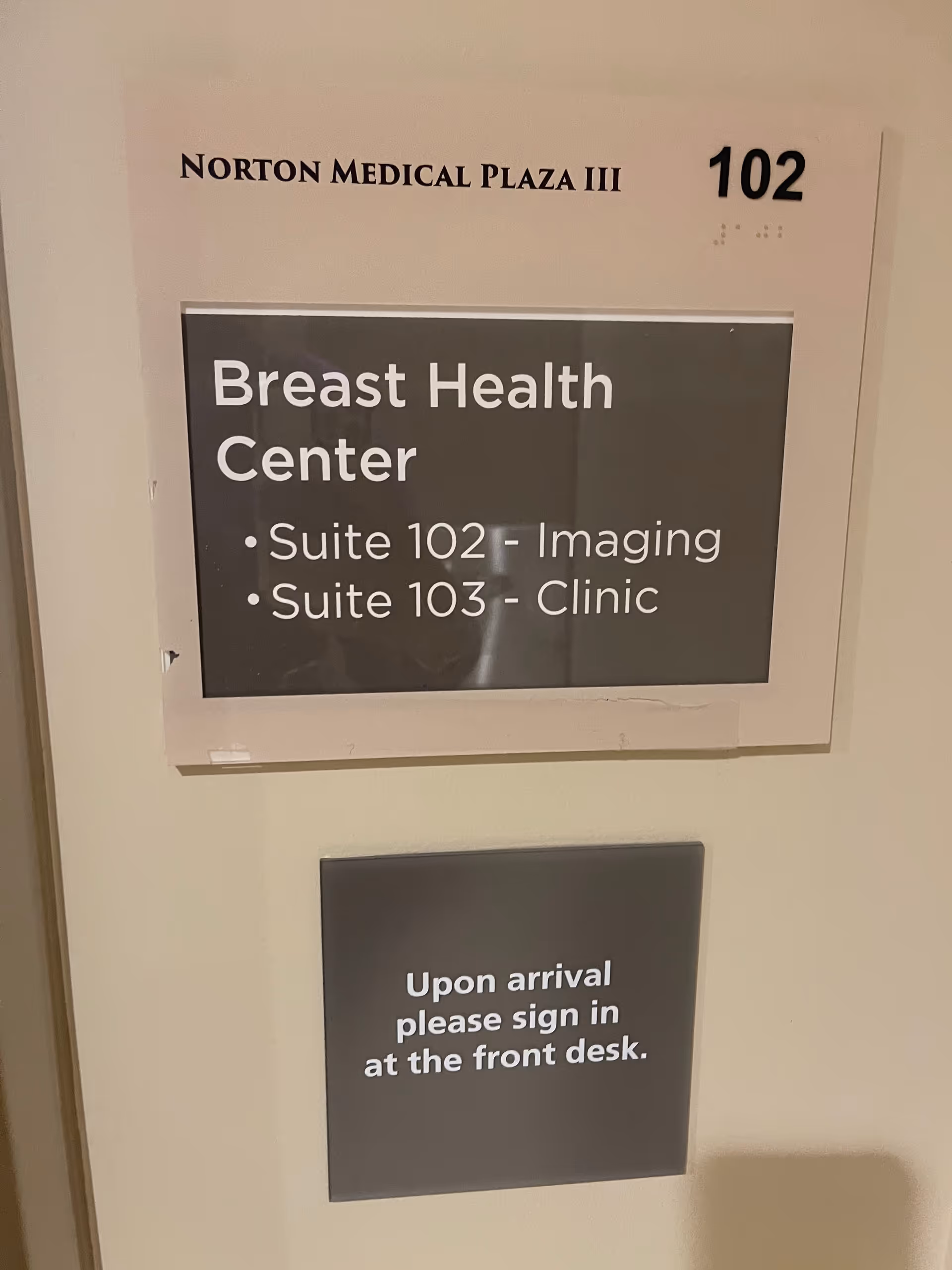 Interior hallway sign for Norton Medical Plaza III with Breast Health Center suites 102 and 103