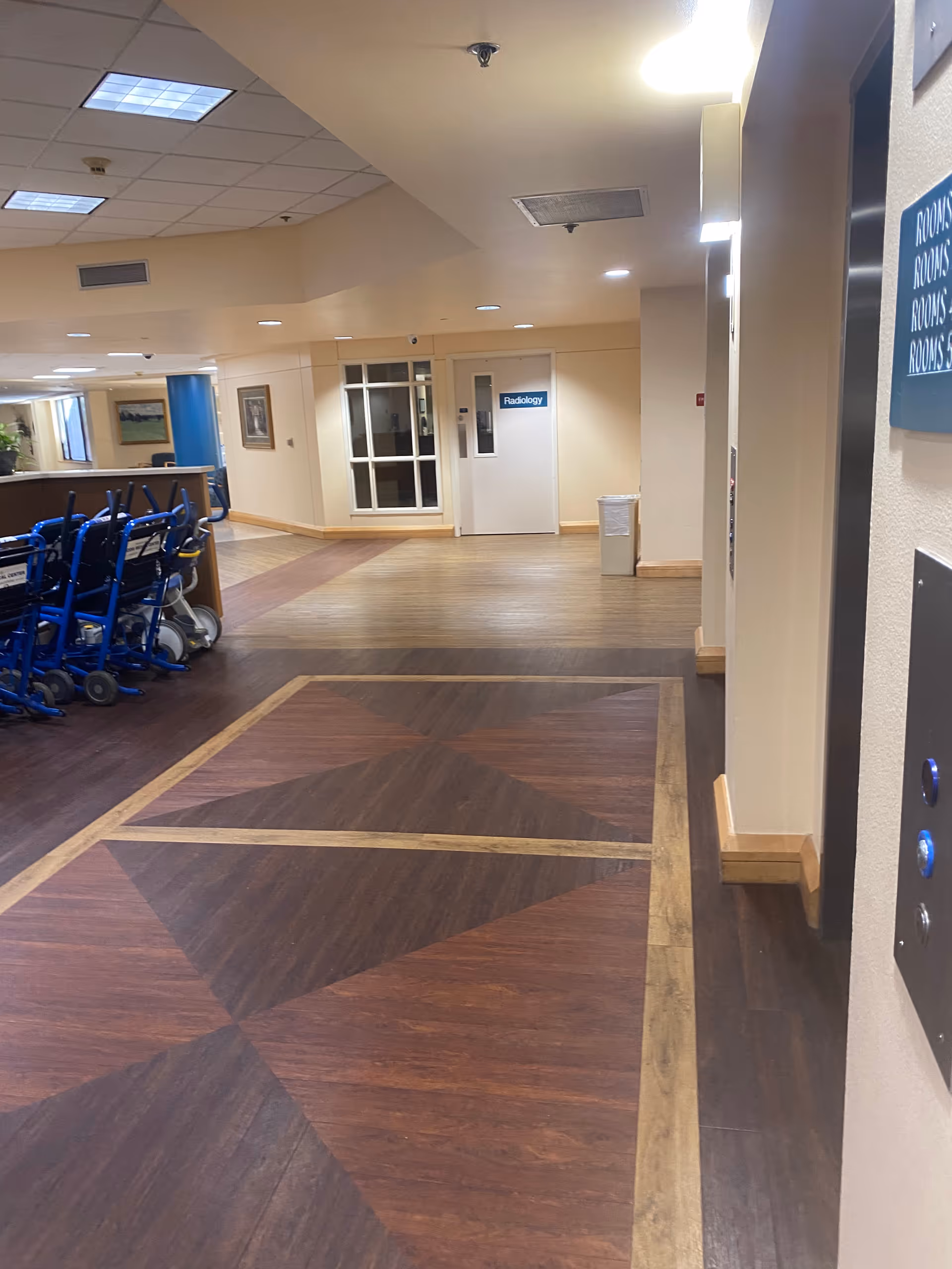 Interior corridor of Citizens Medical Center featuring wood-patterned flooring and closed doors.