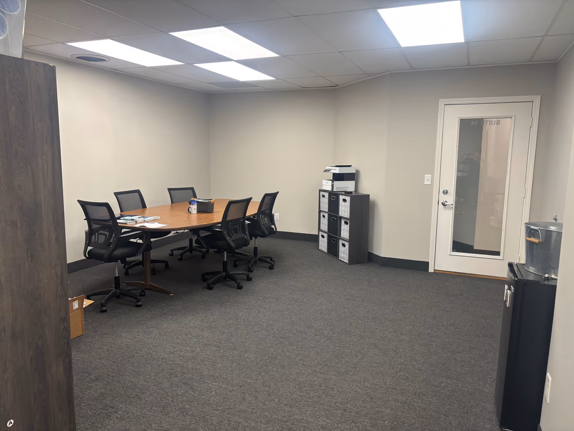 An empty conference room in Cornerstone Caregiving with an oval table and chairs.